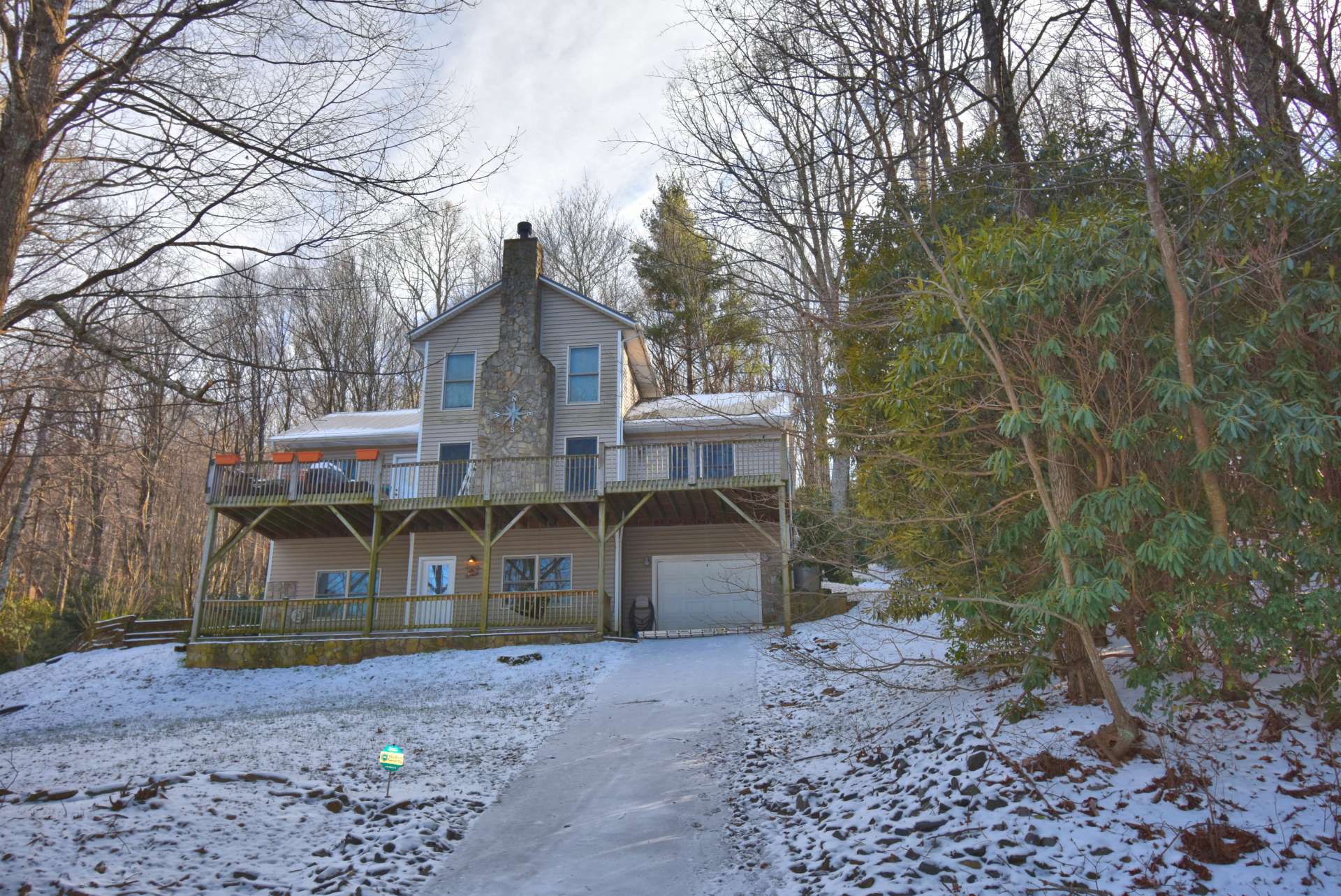 The garage features a second paved driveway access.