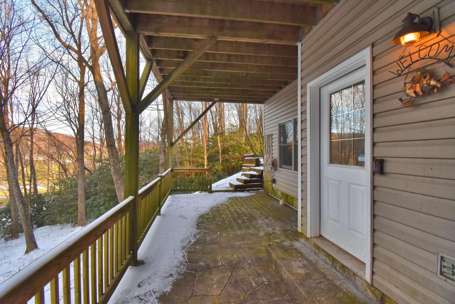 The lower level den area features access to the lower level deck.