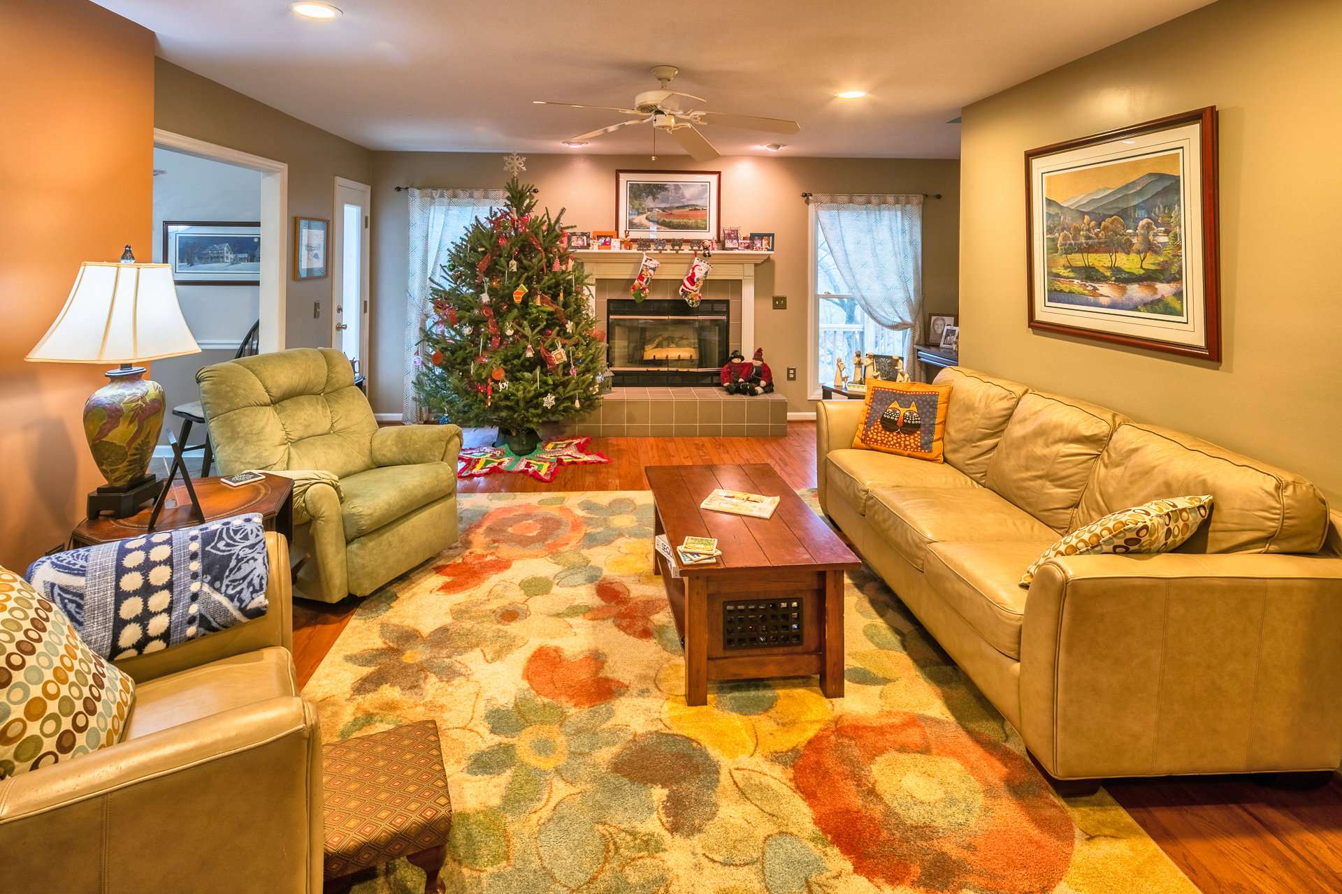 The living area welcomes you with warm and inviting spaces featuring wood floors and a fireplace with gas logs.