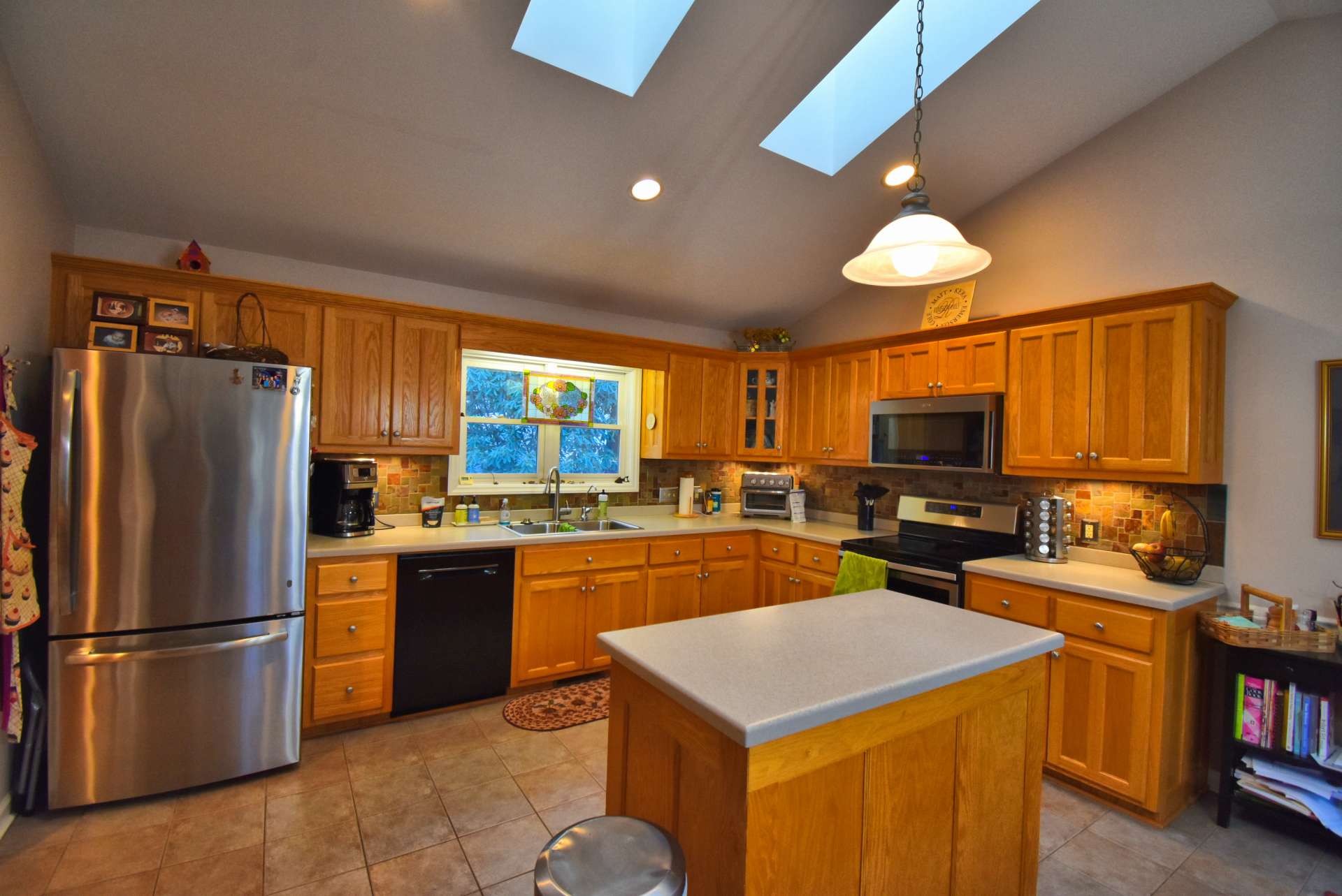 This spacious kitchen provides space for help for meal preparation and cleanup.