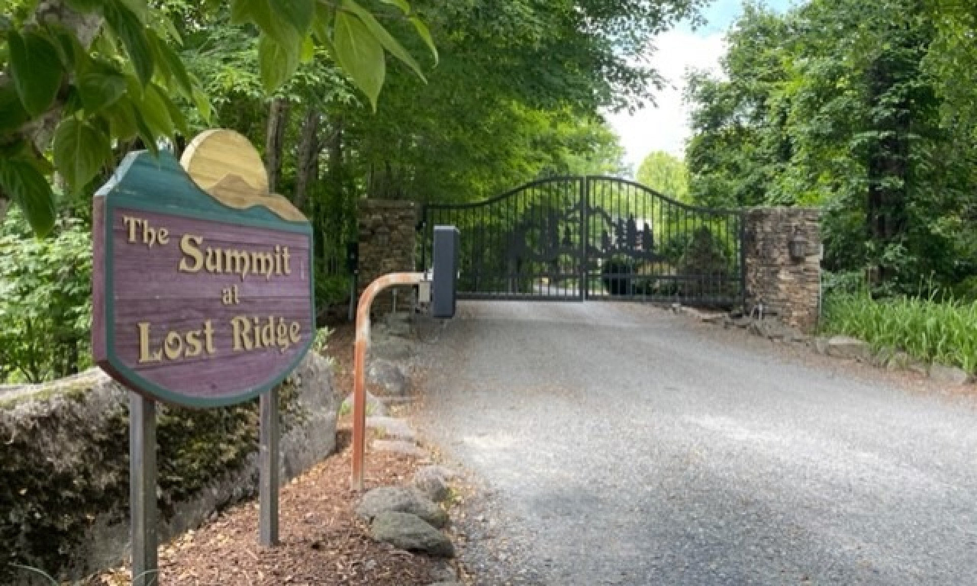 Well maintained entrance with custom gate. Easy to use electronic gate keypad beside the entry sign.