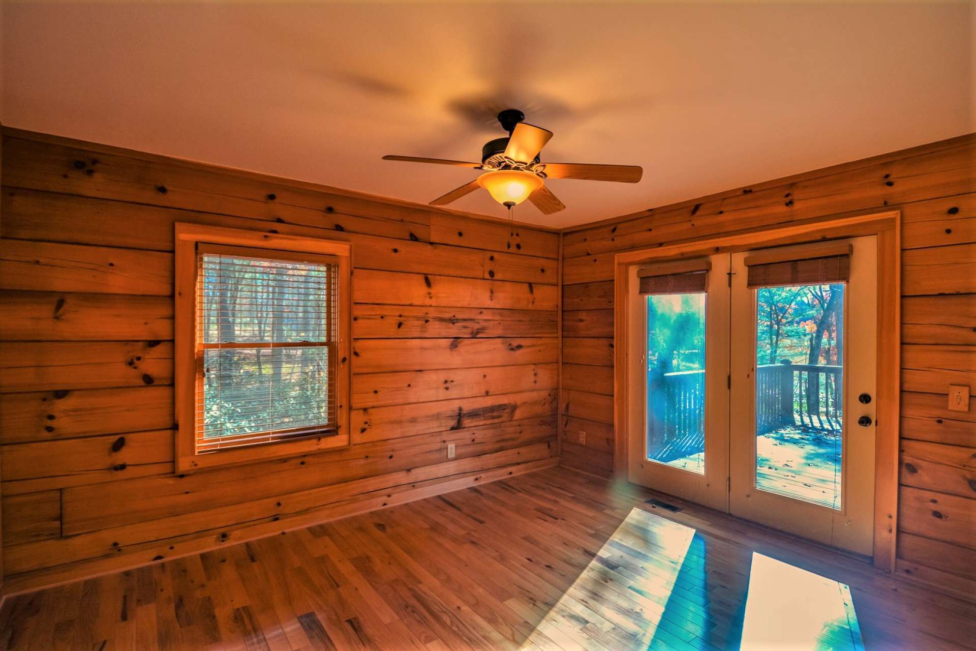 Two guest bedrooms share a full bath and complete the main level. This guest bedroom also offers private access to the deck.