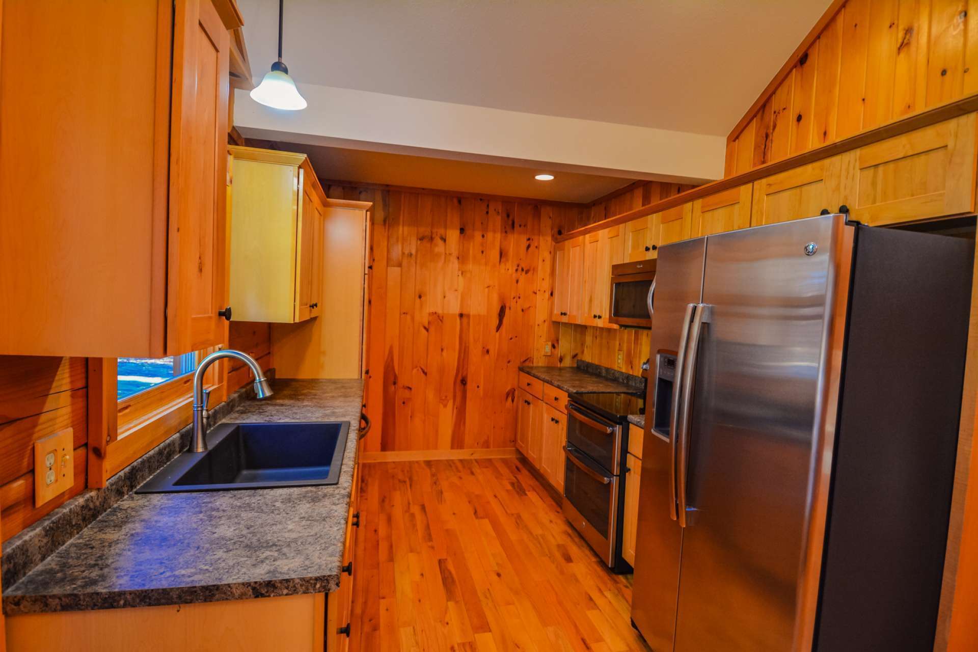 The galley style kitchen offers stainless appliances and ample work and storage space.