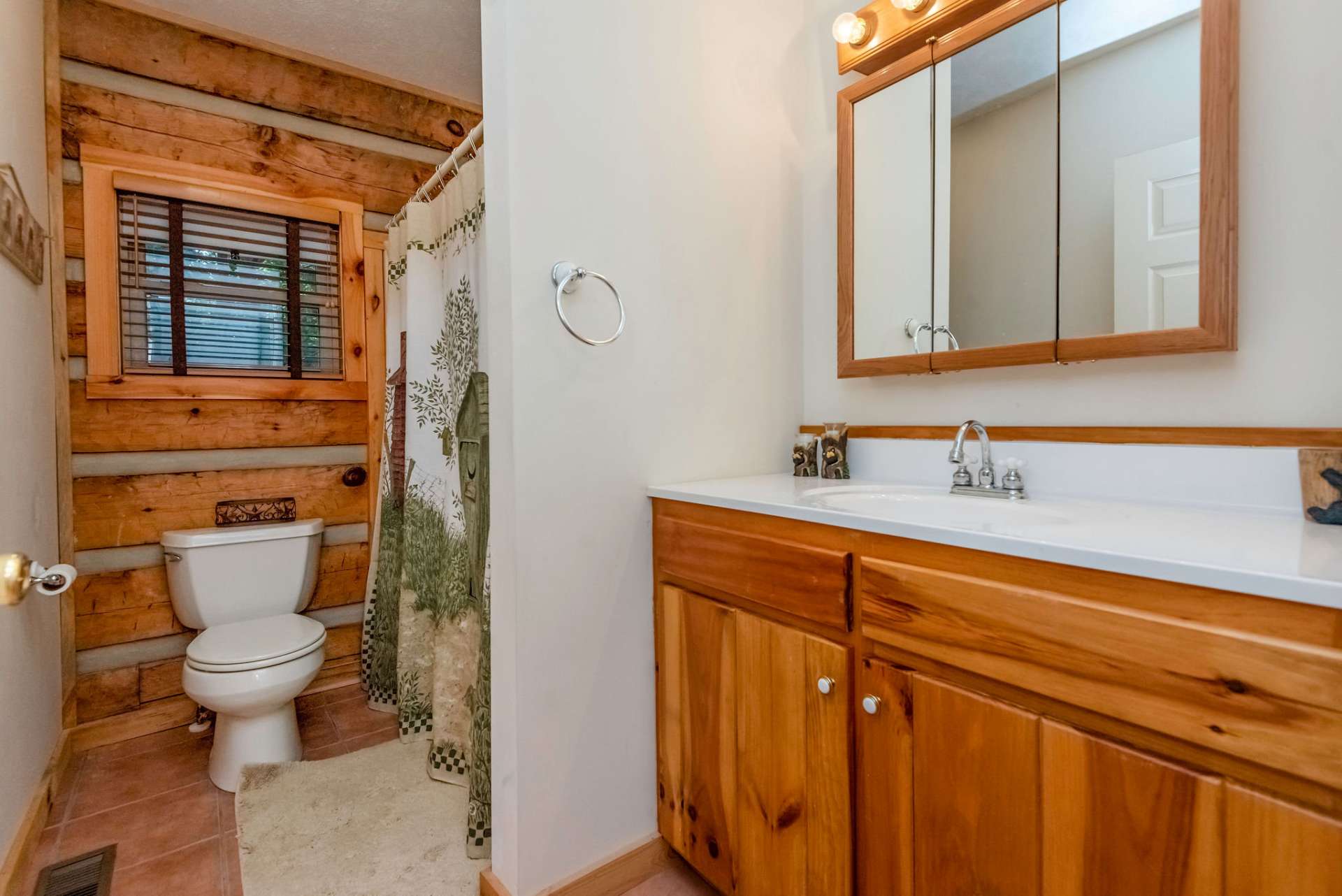 Main level full bath with tub and shower is centrally located in the hall off of the great room.