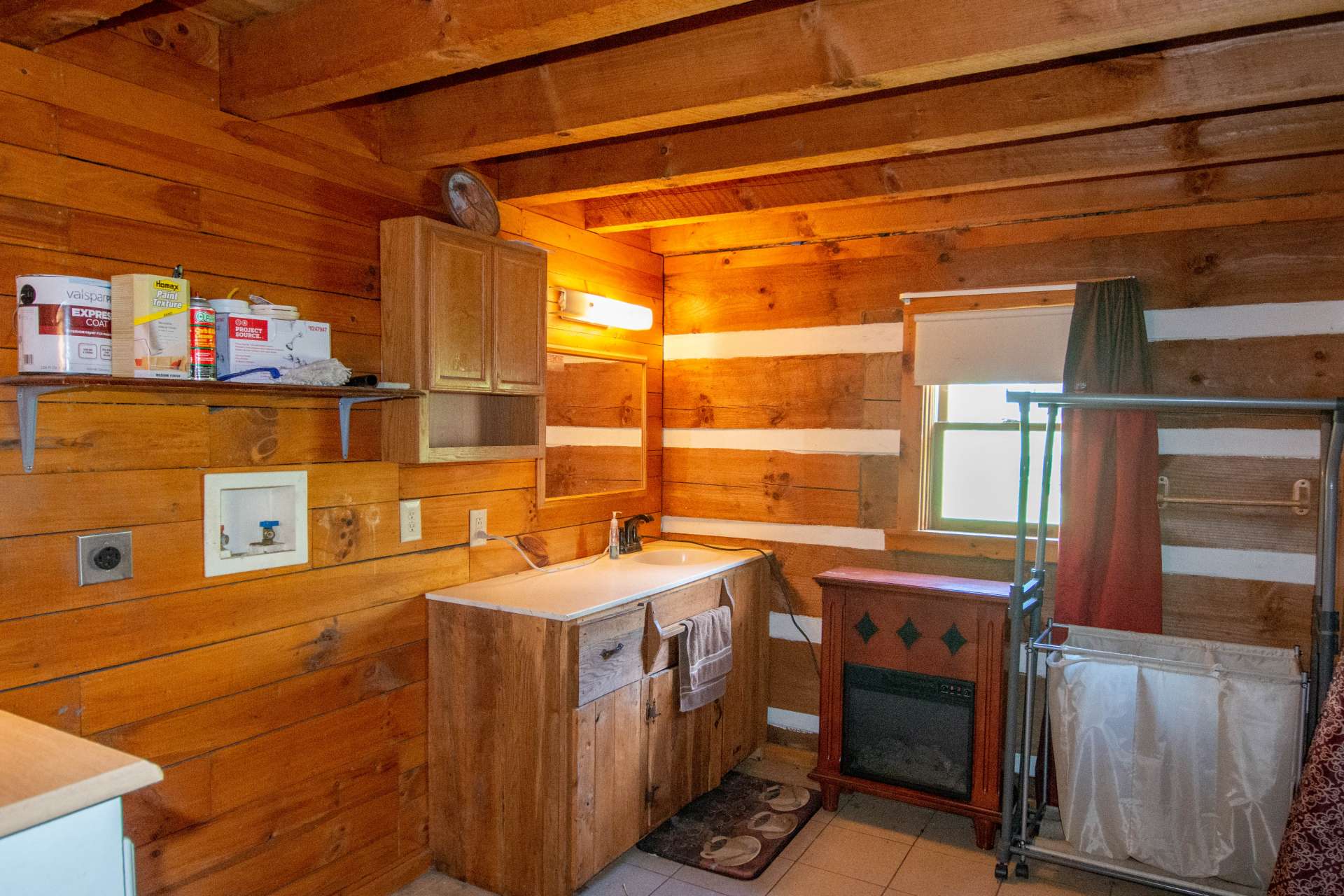 The bath is spacious and includes the laundry area.