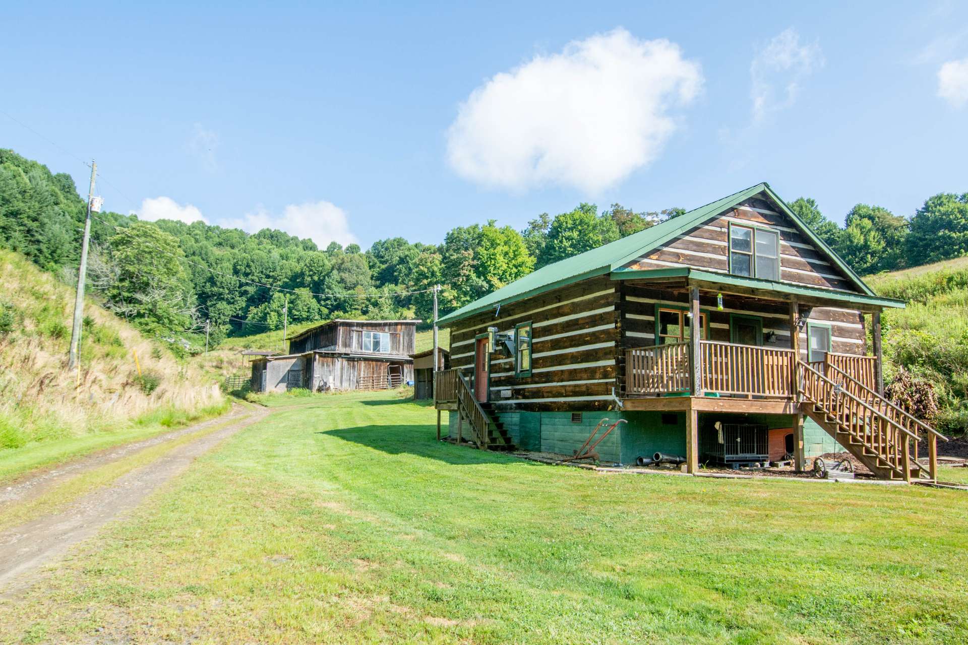 The cabin sits on a peaceful acre setting with an additional 14+ acres of pasture land and a barn available.