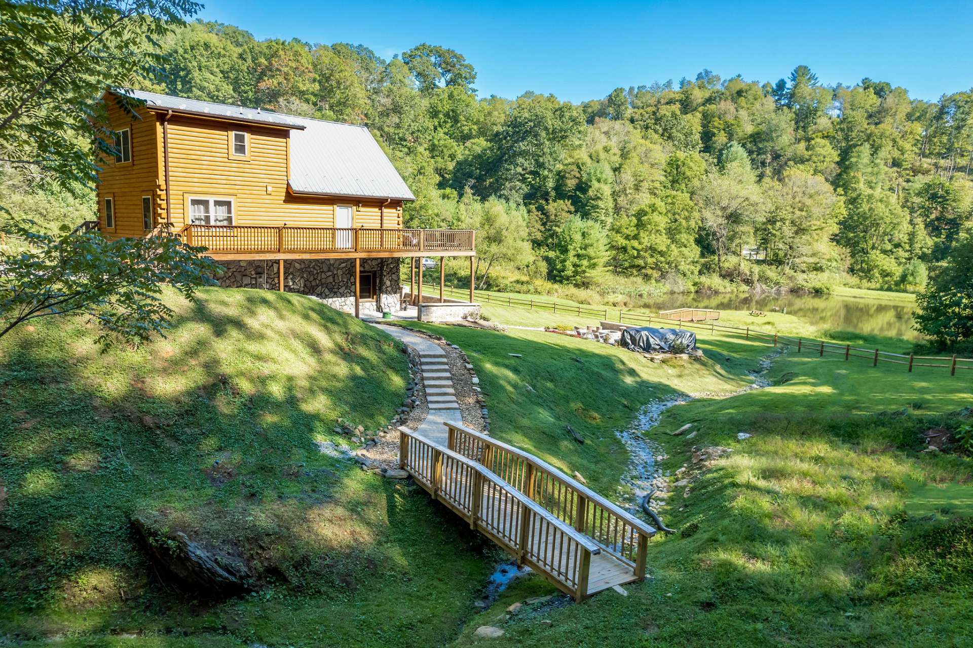 The setting offers a small mountain stream meandering through the yard.