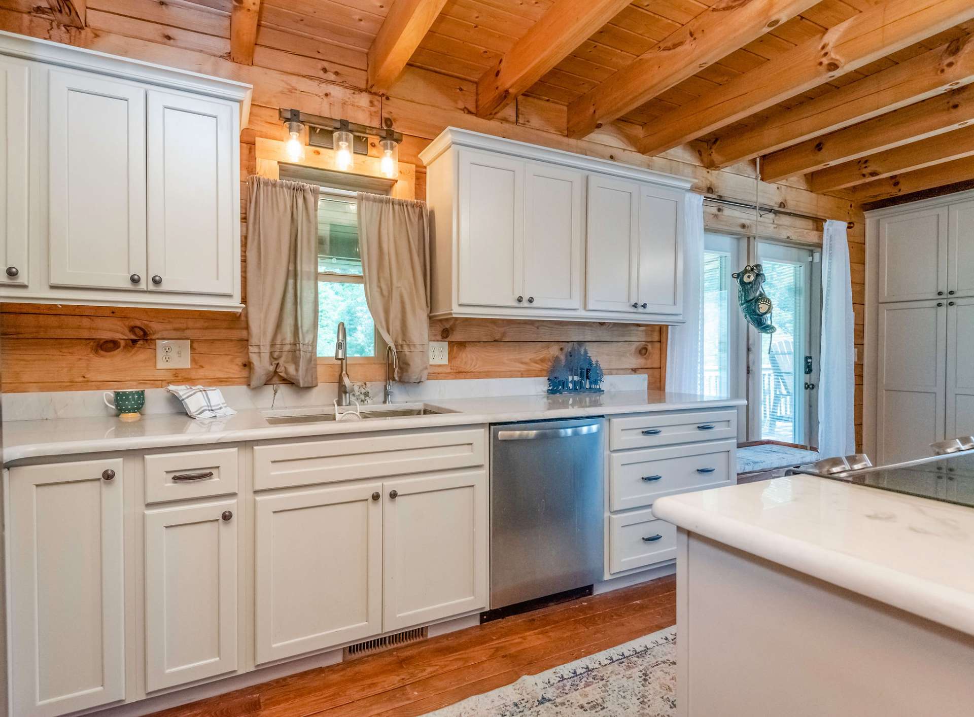 The white cabinets and accents mellow out the warmness of the pine interior in this lovely home.