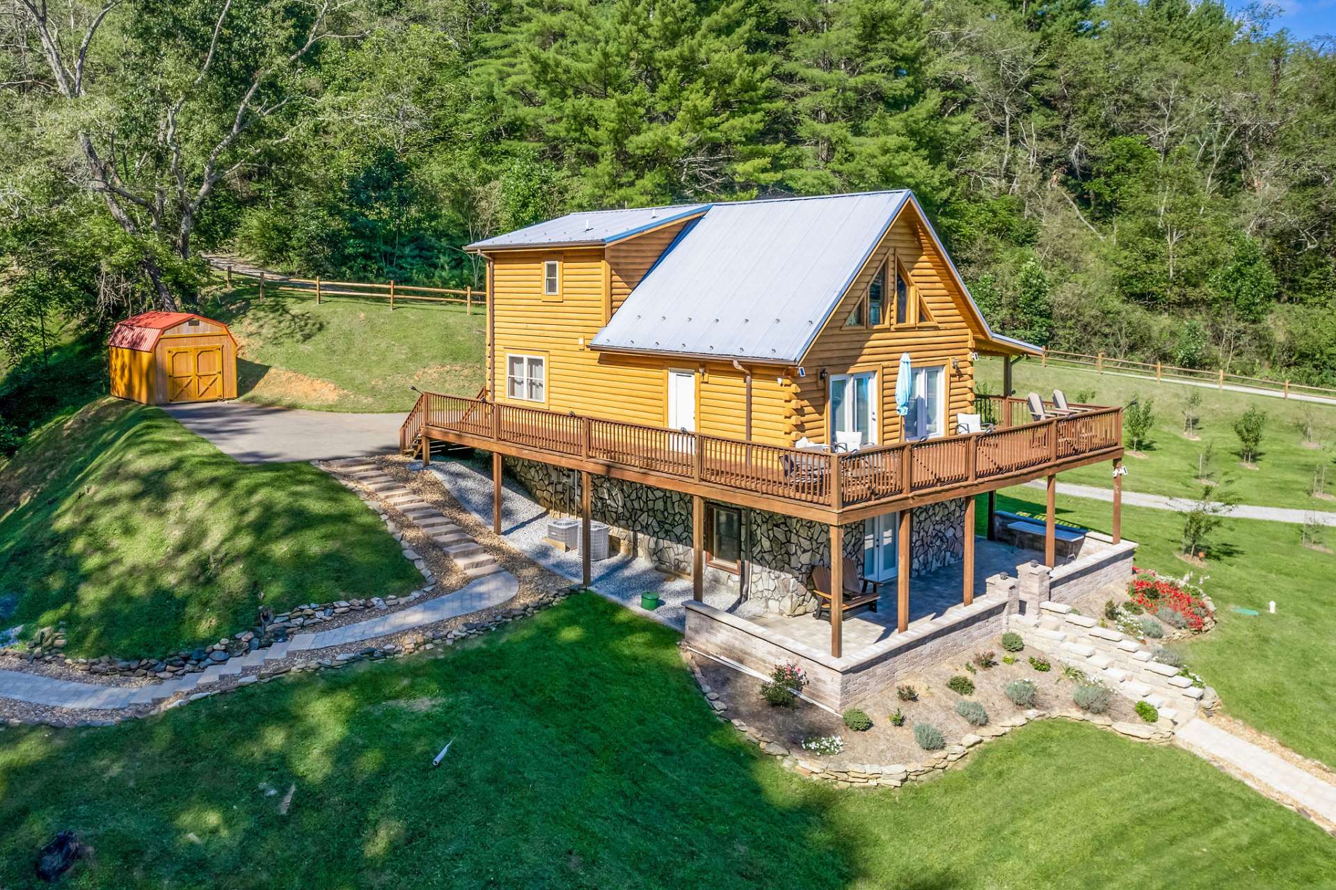 The cabin features a view of the community pond with the Mountains beyond.