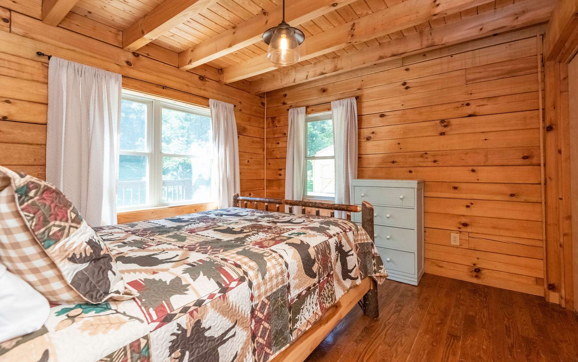 Main level bedroom with view of stream and bridge.