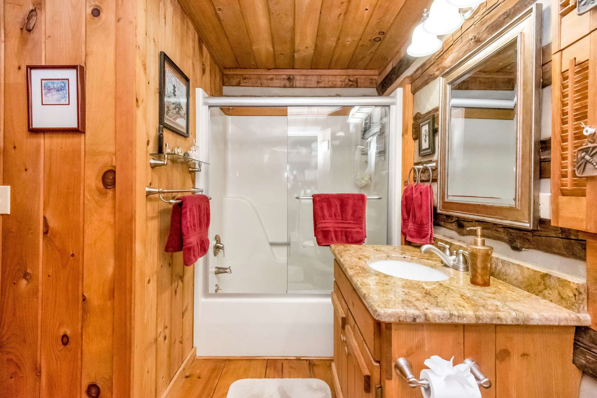 Main level bath with granite counter tops and tub/shower combo.