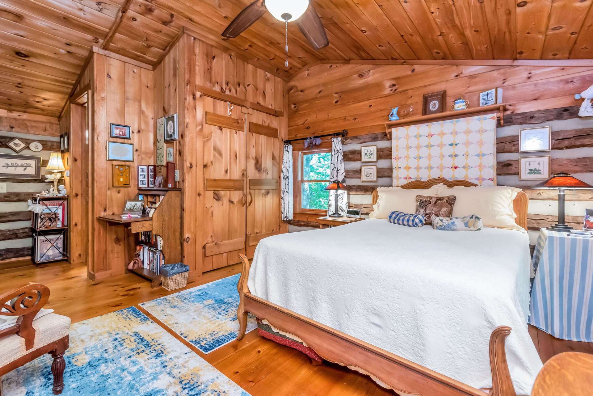 This inviting room is light and airy with abundant windows and closets plus vaulted wood ceiling reflecting the warm and cozy tones.