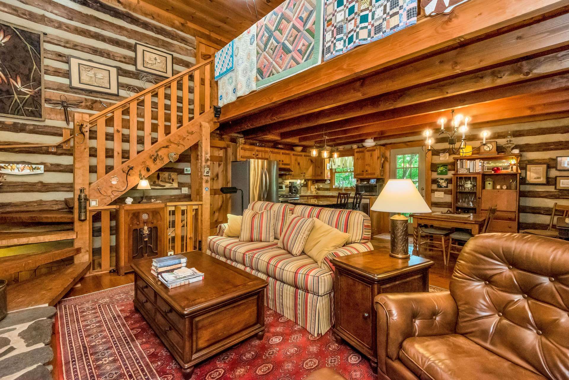 The masterly crafted hand-hewn stairway leads you to the open loft.