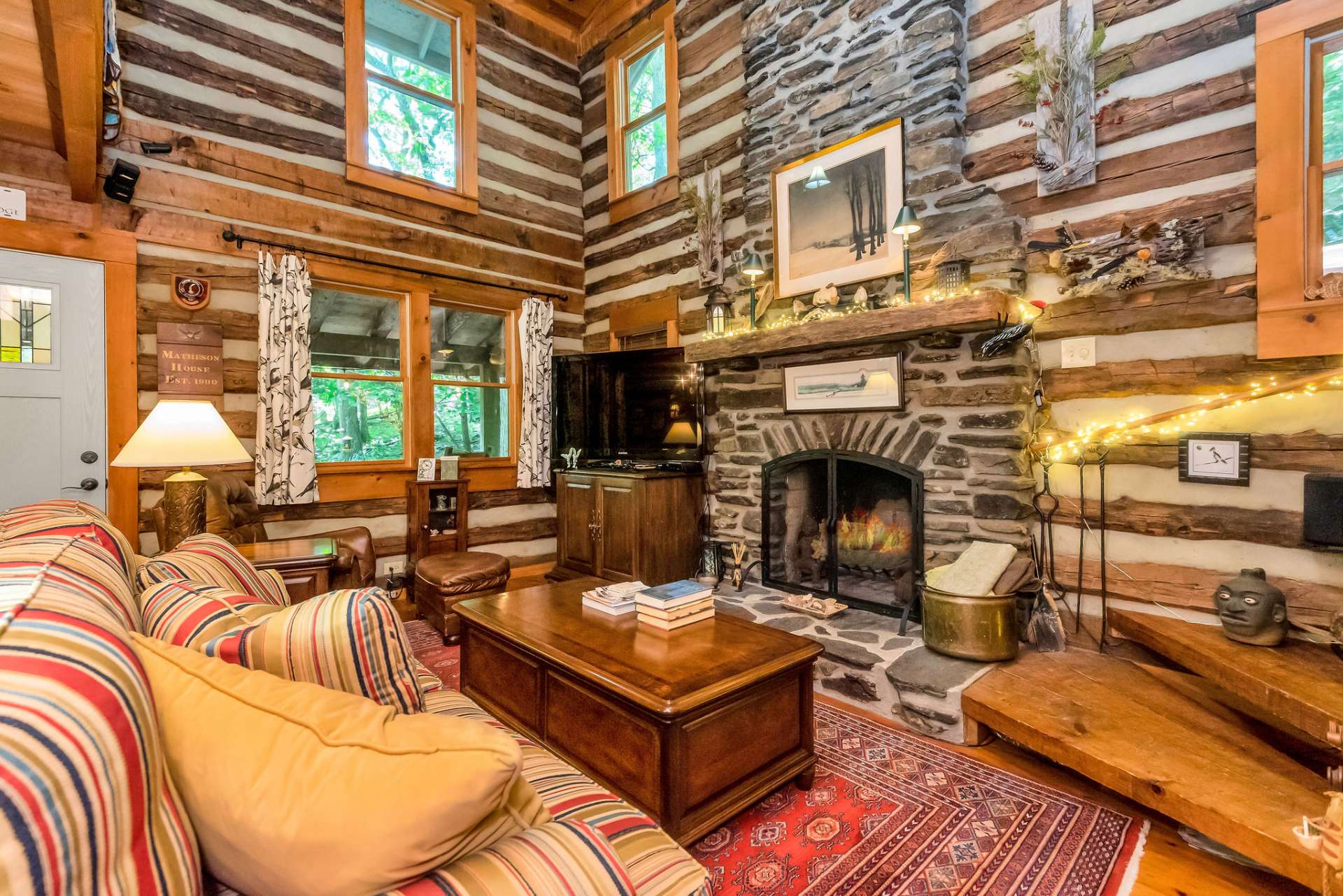 The focal point of this room is the grand floor-to-ceiling wood-burning fireplace.