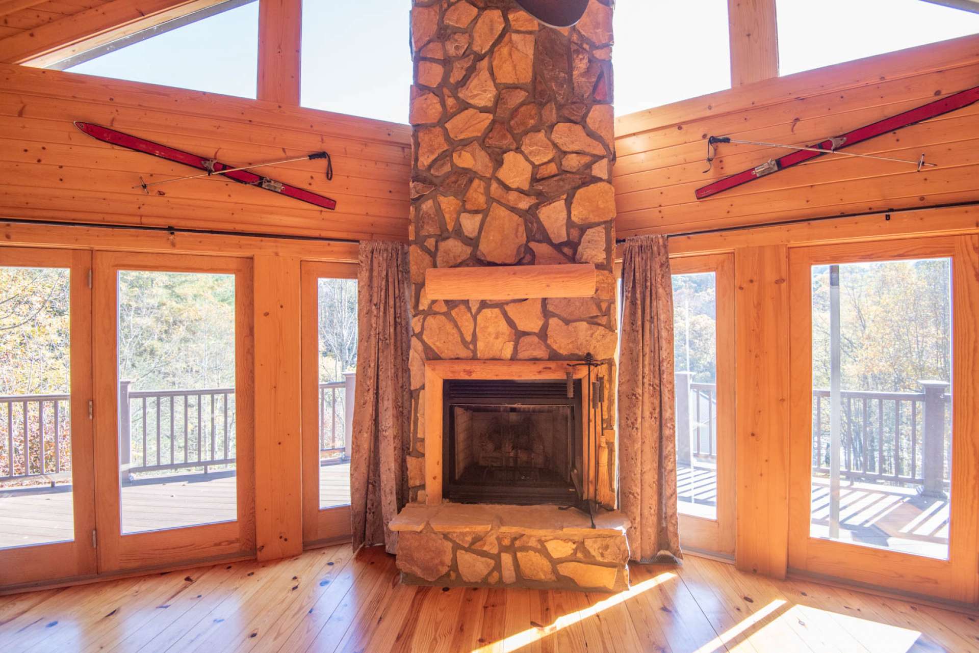 Floor to ceiling fireplace flanked by abundant windows for natural light.