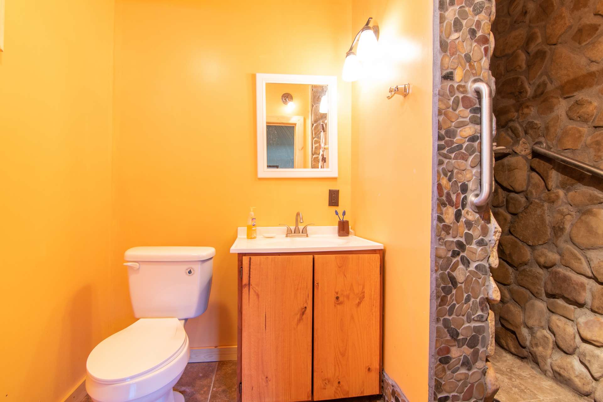 The lower level bath features a walk in shower with stone surround.