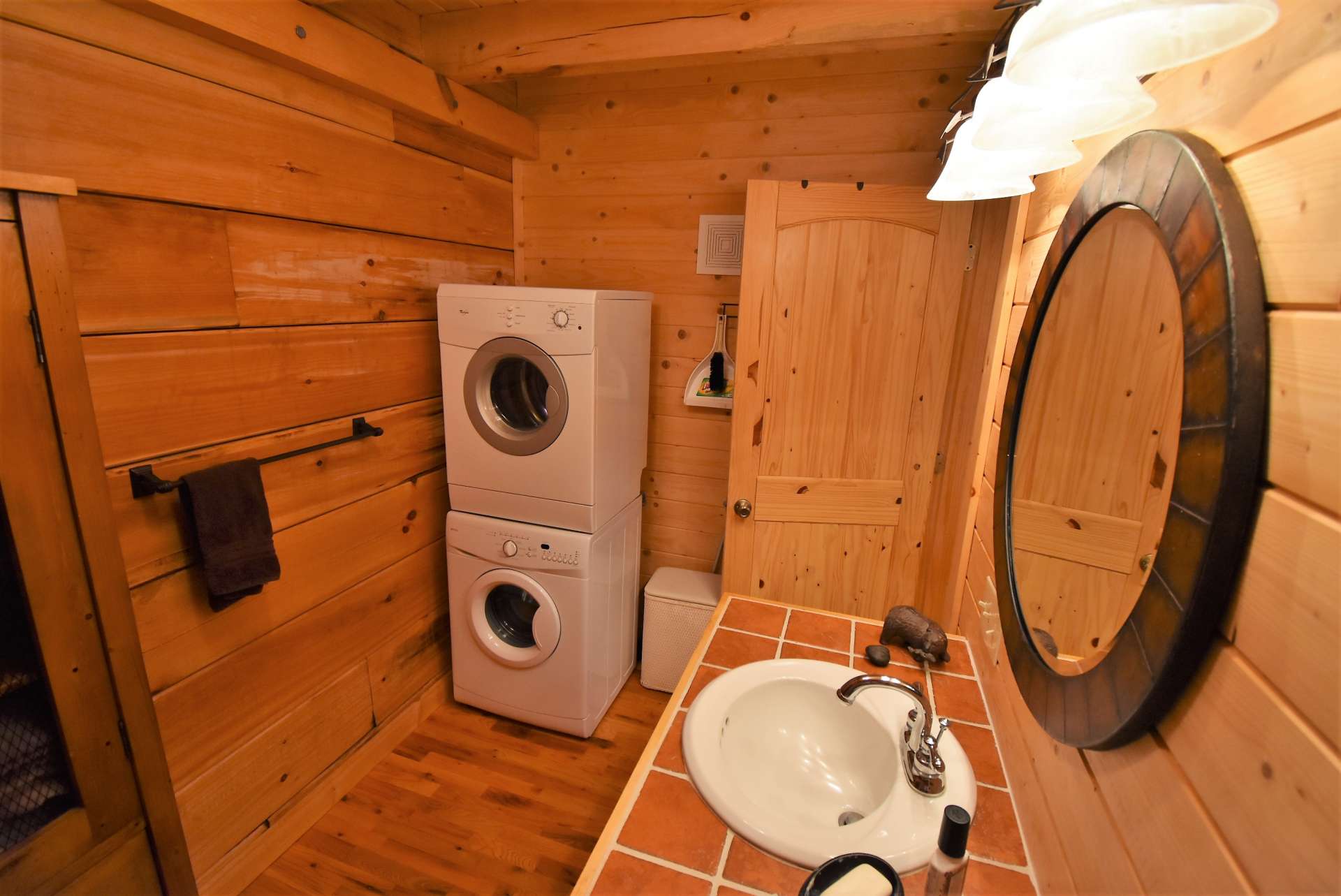 The main level bath also includes the laundry area.