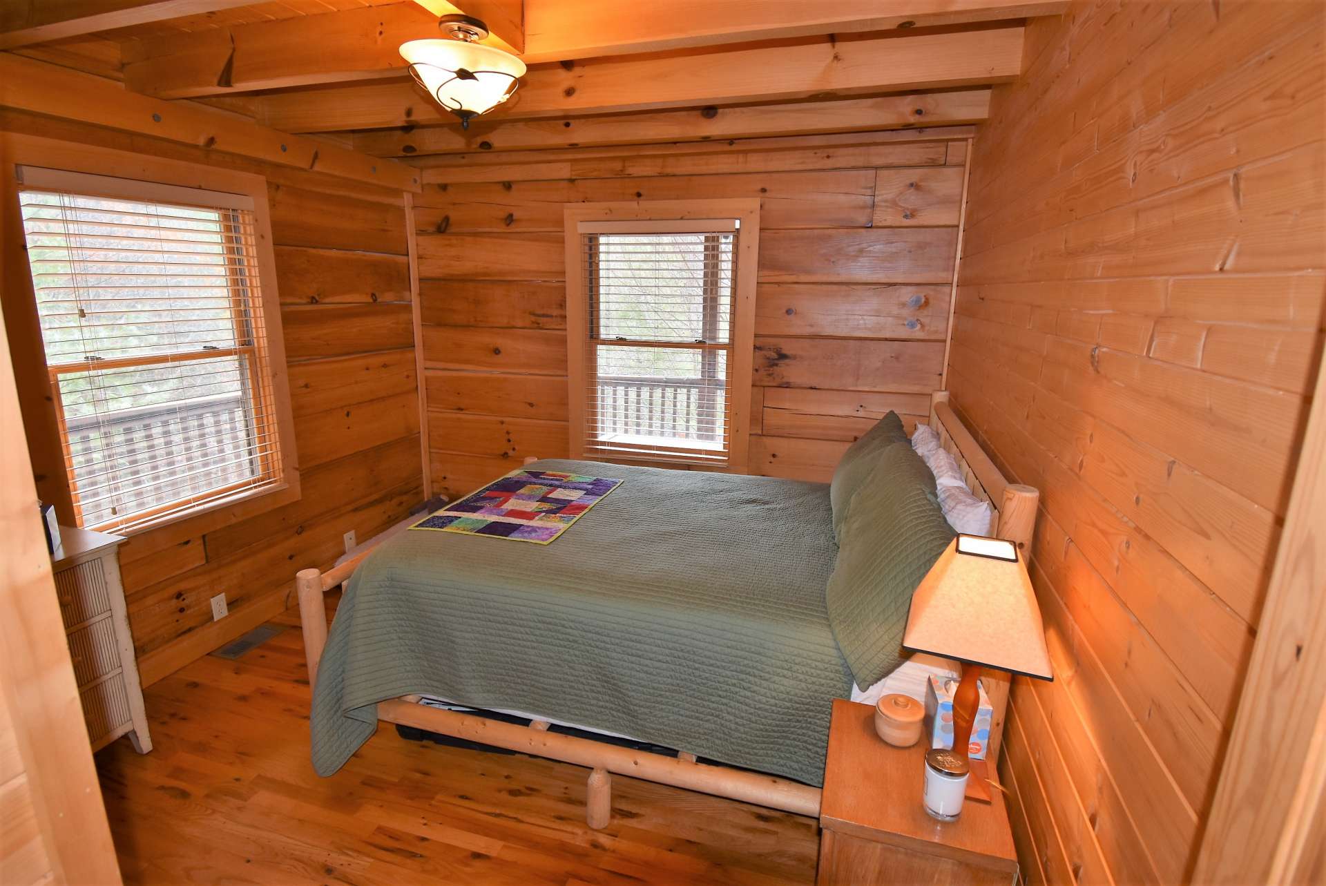 The main level bedroom is  amply sized with exposed beams and features lots of natural light.