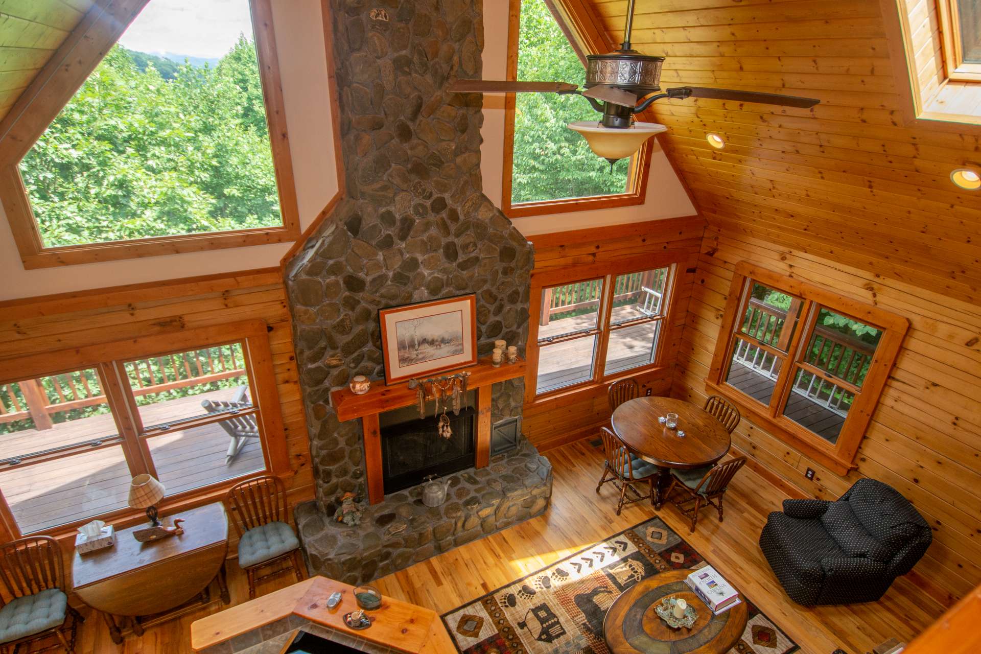 Welcoming you home, this native Ashe County river rock fireplace features easy care gas logs and a stunning heavy beamed mantle.