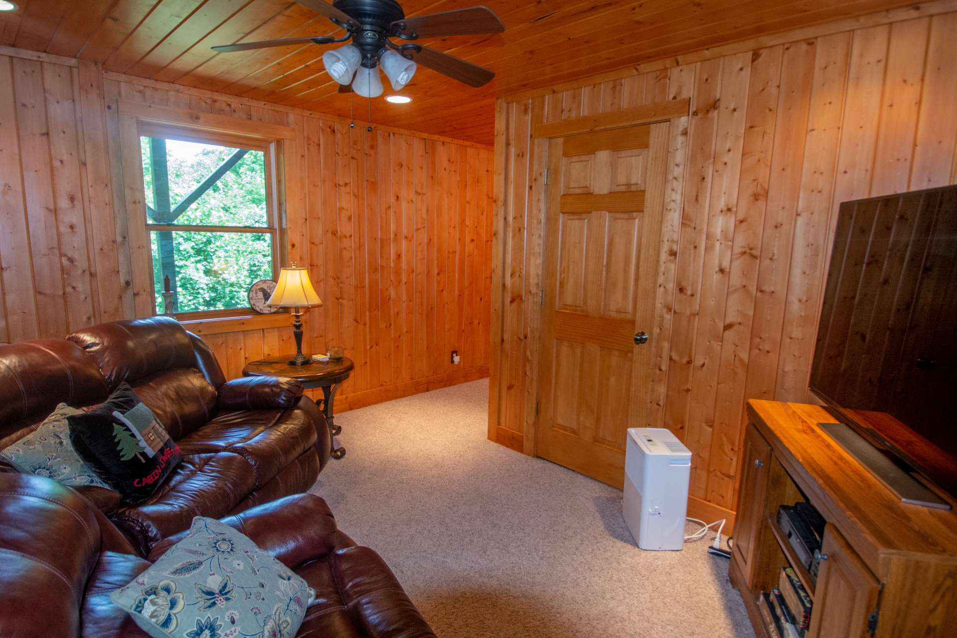The lower level offers finished living space and a half bath.