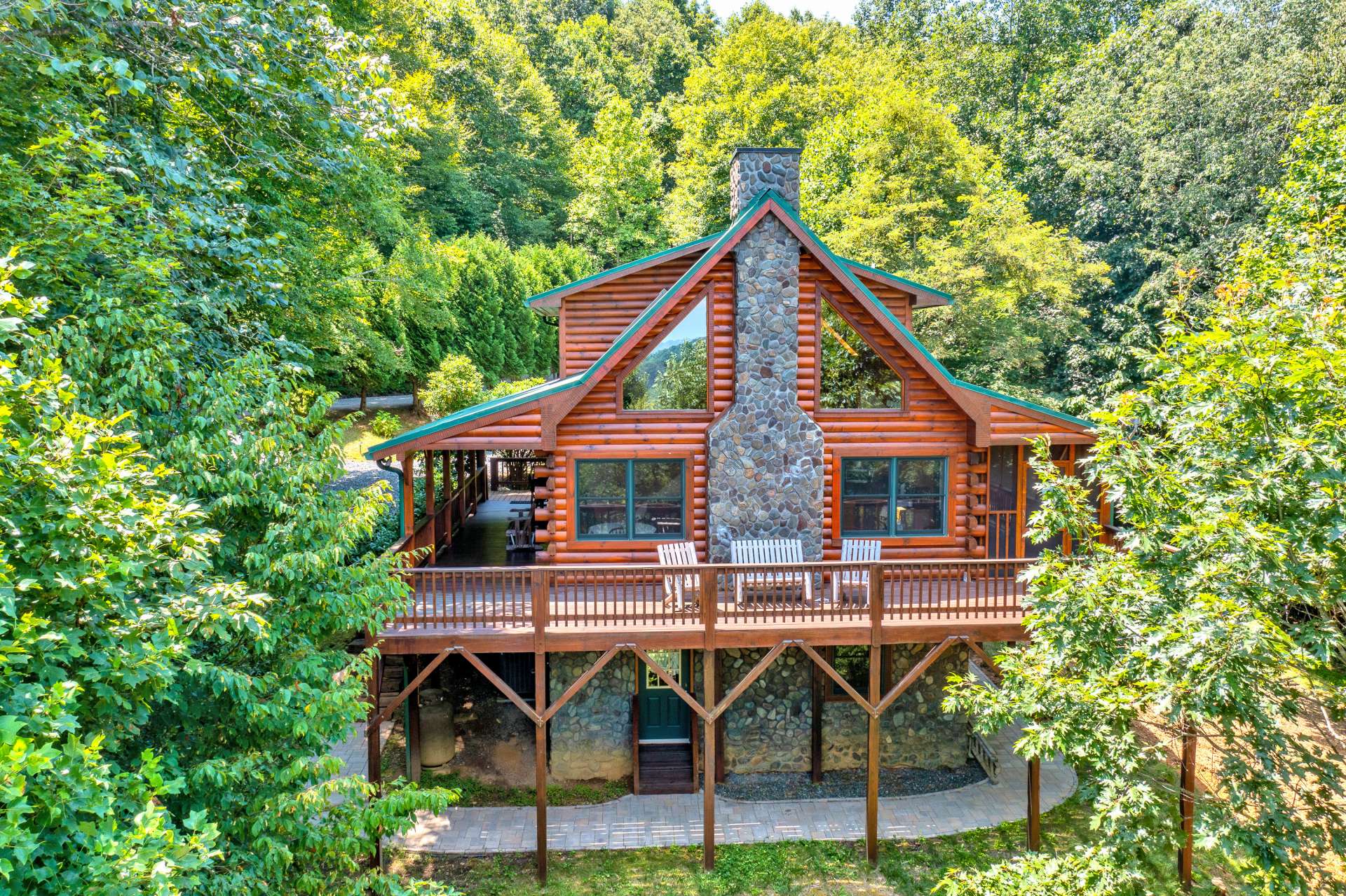 Multiple covered porches and extended decking offer abundant outdoor dining and entertaining space surrounded by Nature.