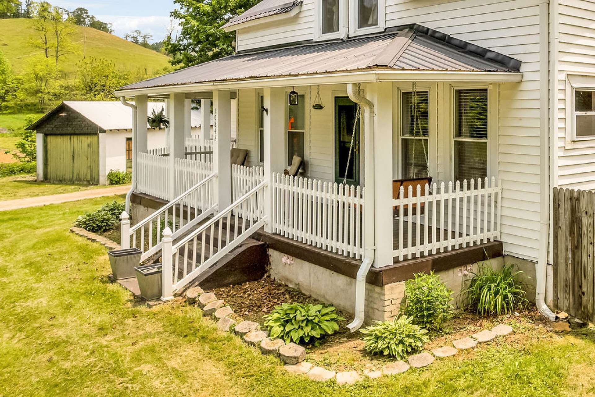 Covered front porch wraps around for Southern Style outdoor living.