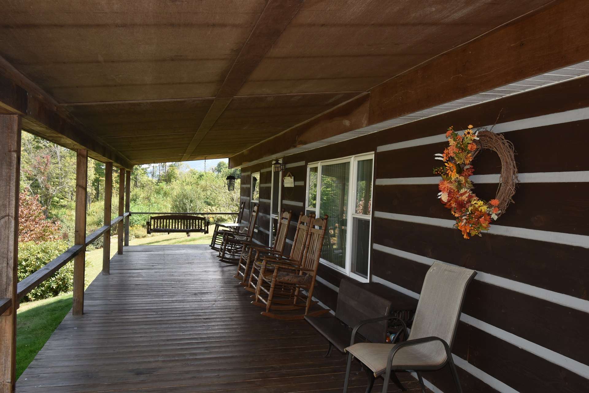 A full length covered rocking chair front porch welcomes you sit awhile to enjoy the views.