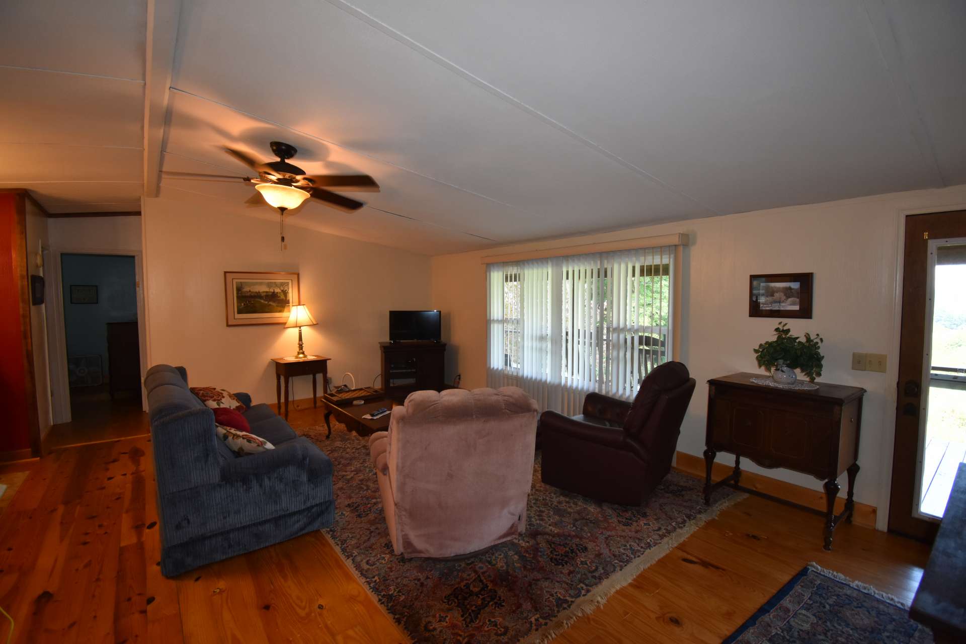 The light filled living area offers wood floors and is open to the kitchen and dining areas.