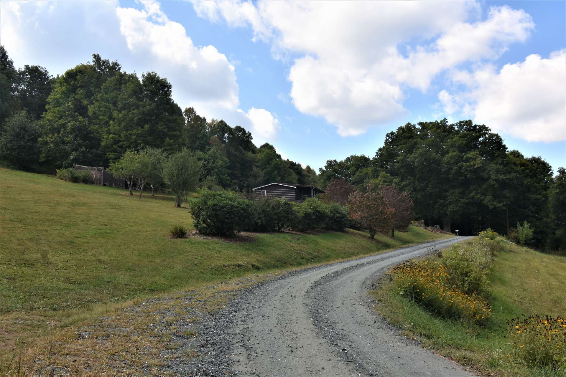 Accessed via a graveled driveway off of Peak Road in the Creston area of Ashe County, this home is convenient to both West Jefferson and the Boone area.