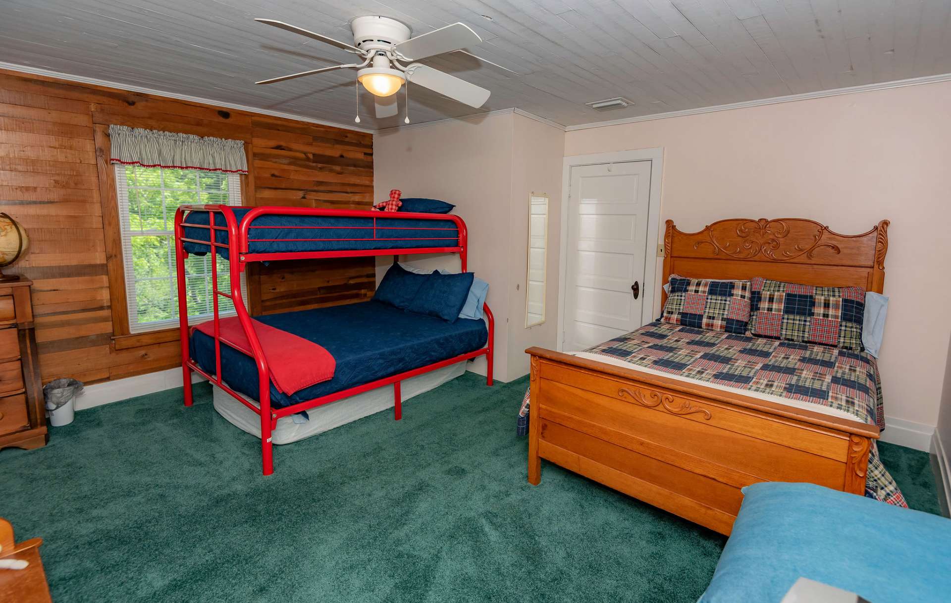 The upper level features two guest bedrooms and the third full bath.