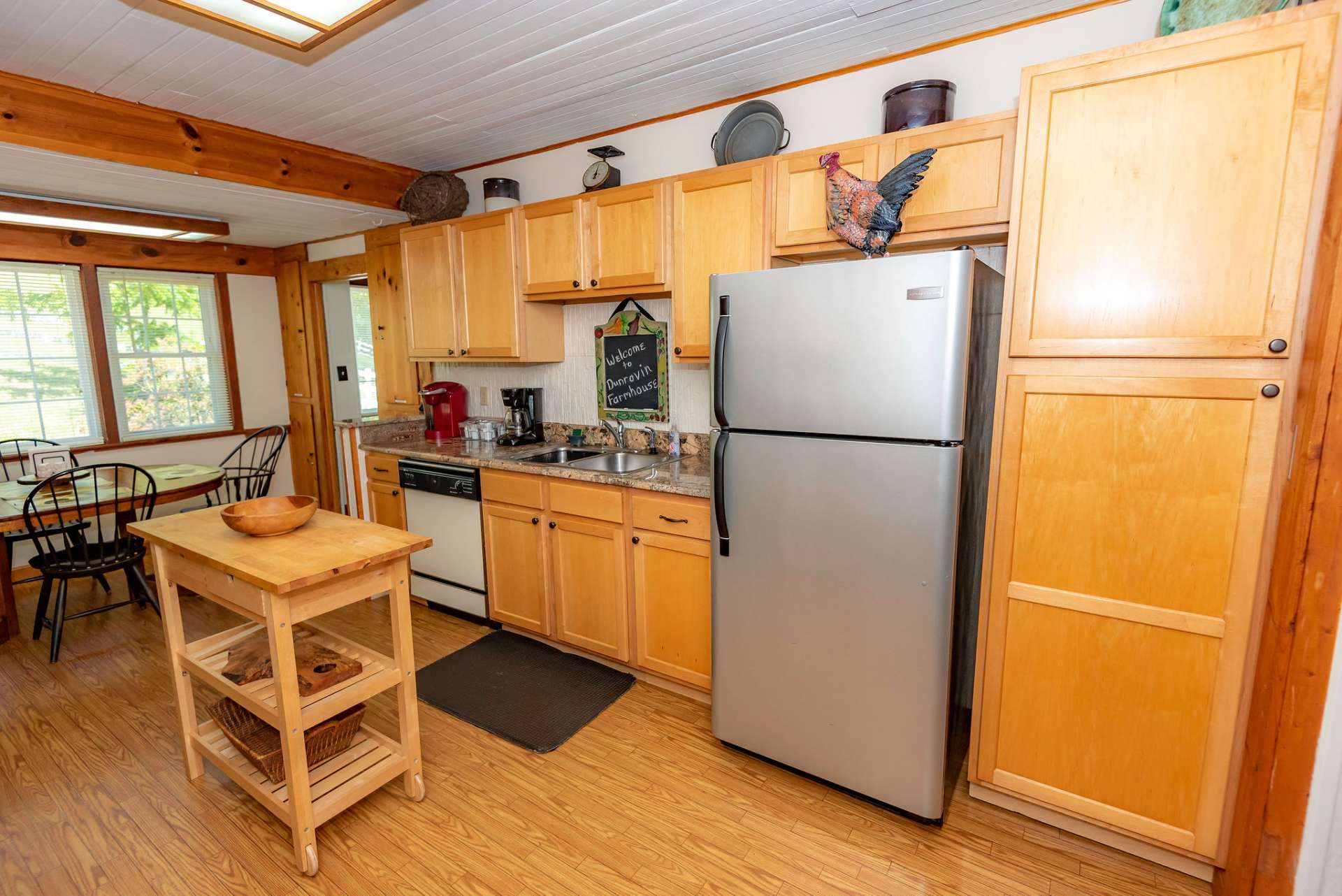 A modern farmhouse style eat-in kitchen offers stainless appliances, and ample work and storage space.