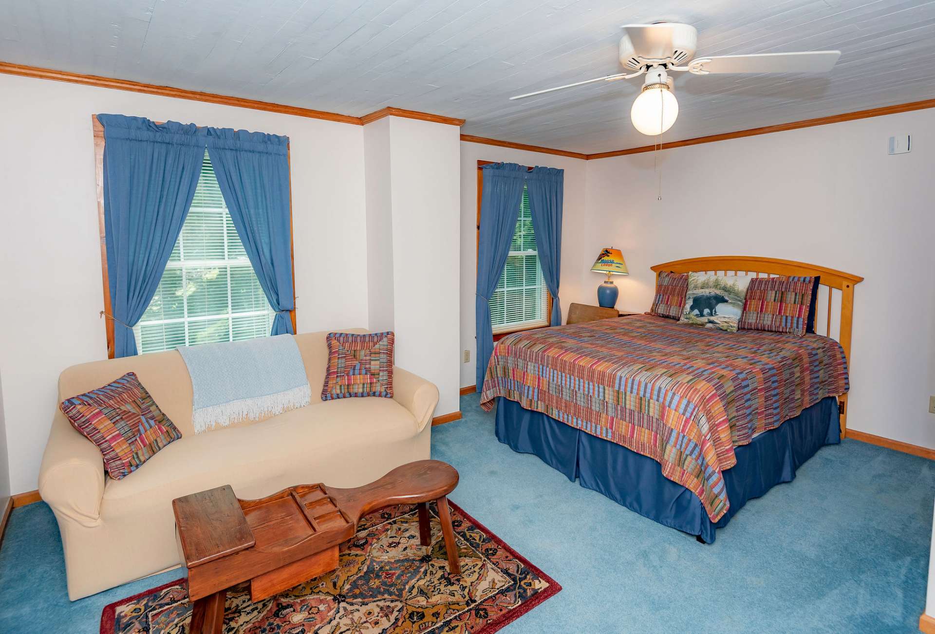 The second upper level bedroom offers lots of natural light and space for a sitting area.