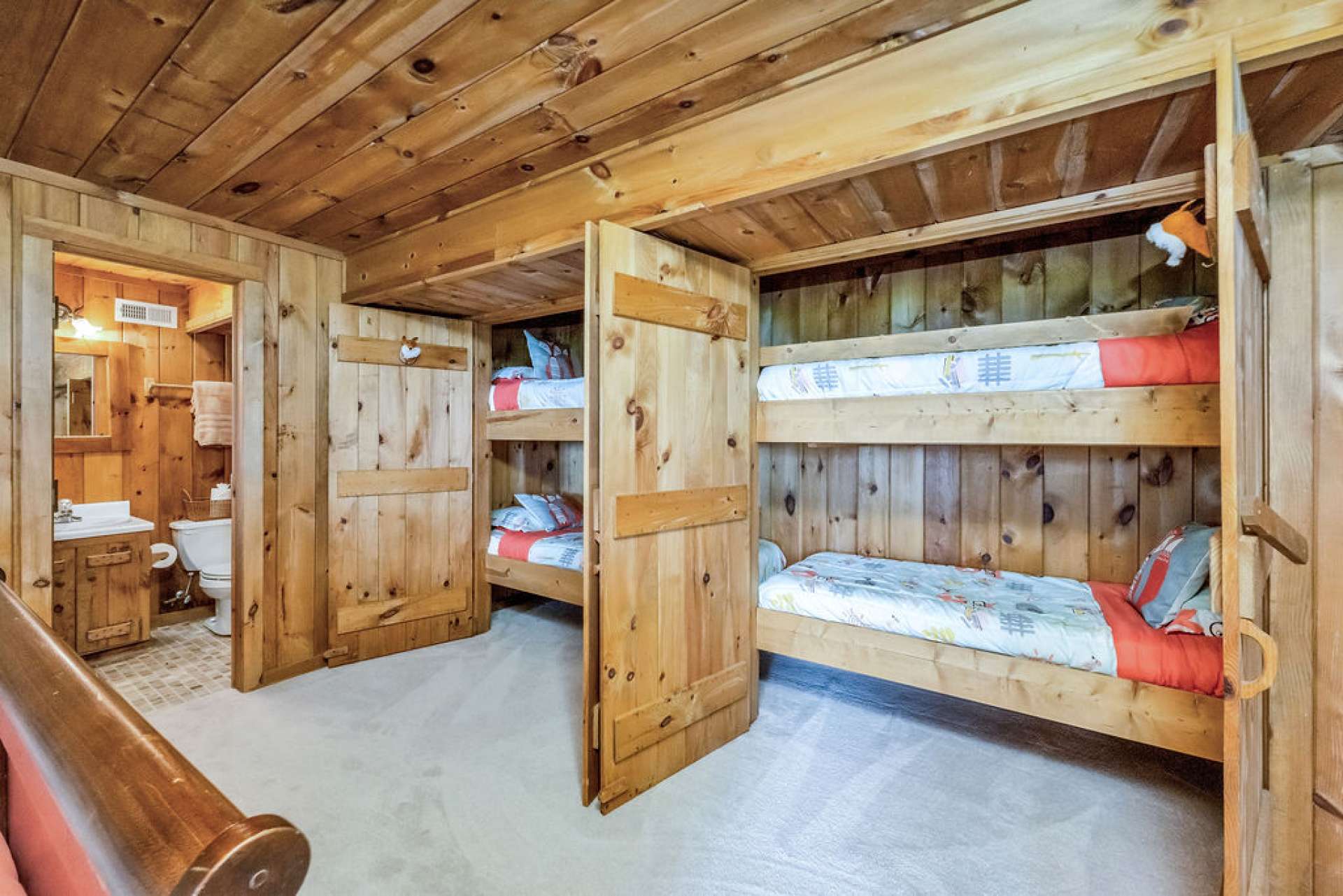 Surprise! Tucked-away bunk beds offer a whimsical retreat for younger guests—and those with a few more years behind them who are young at heart.