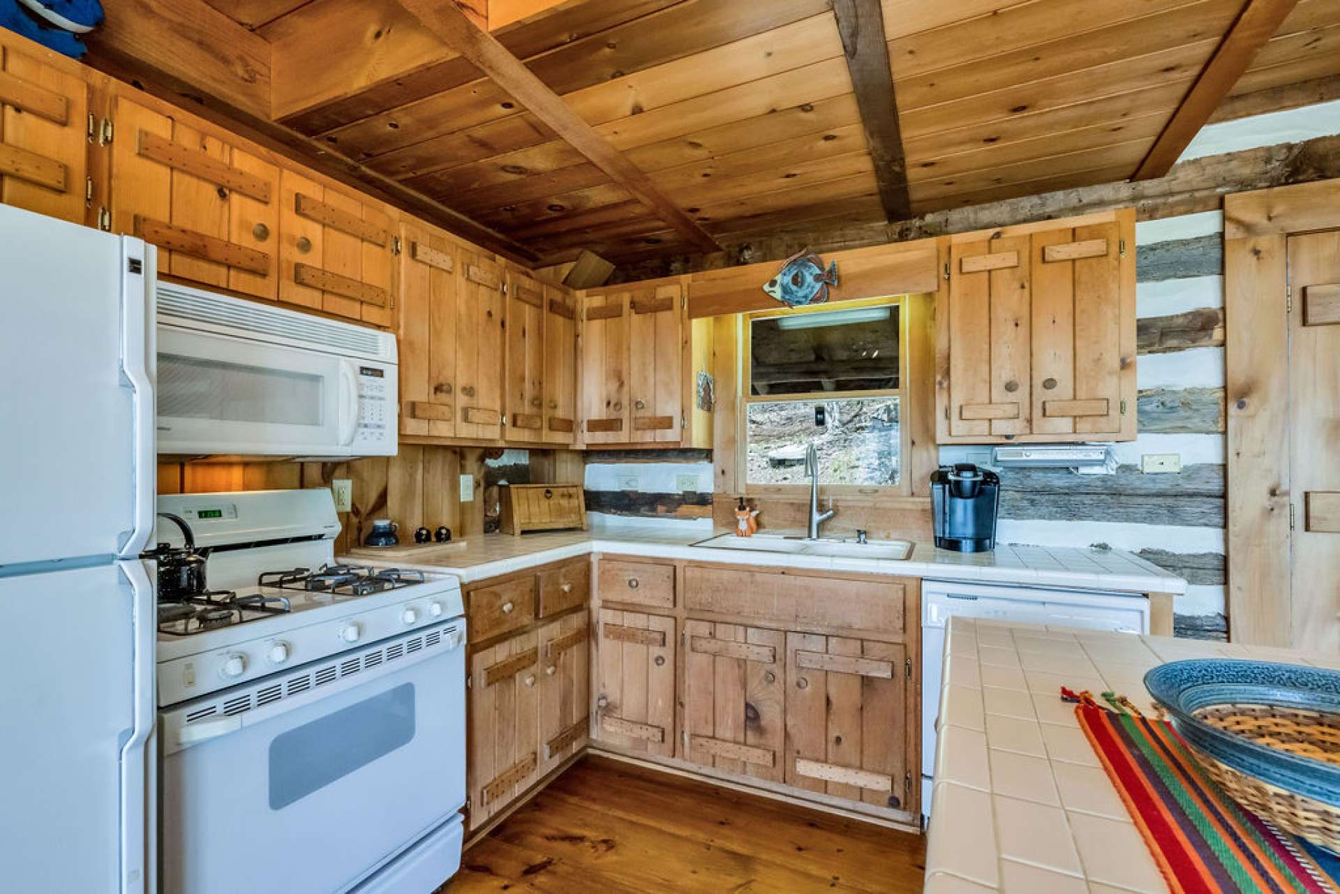 This kitchen features a gas range and abundant storage in the handcrafted cabinets-a unifying design detail in Stonebridge cabins.