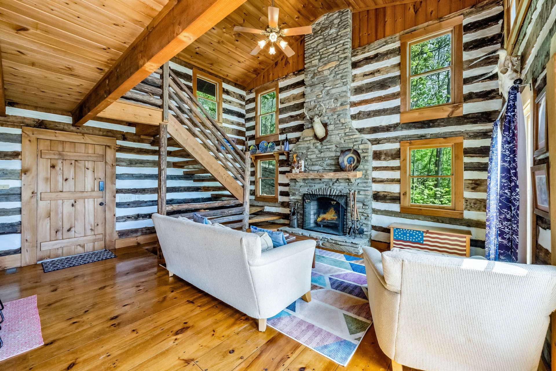 The focal point of the great room is a floor-to-ceiling native stone fireplace.