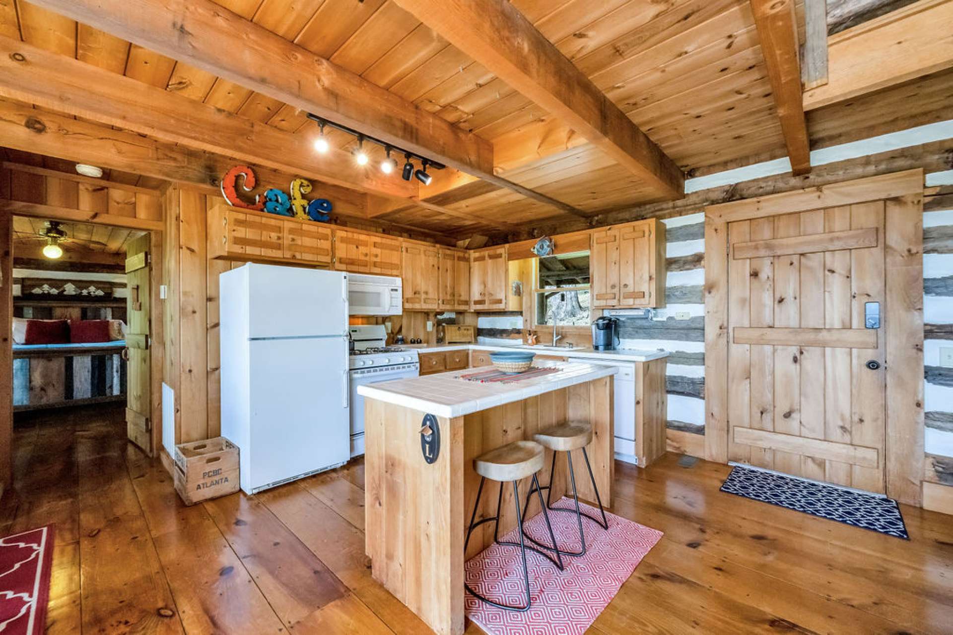 The kitchen features an island with casual seating and additional storage.