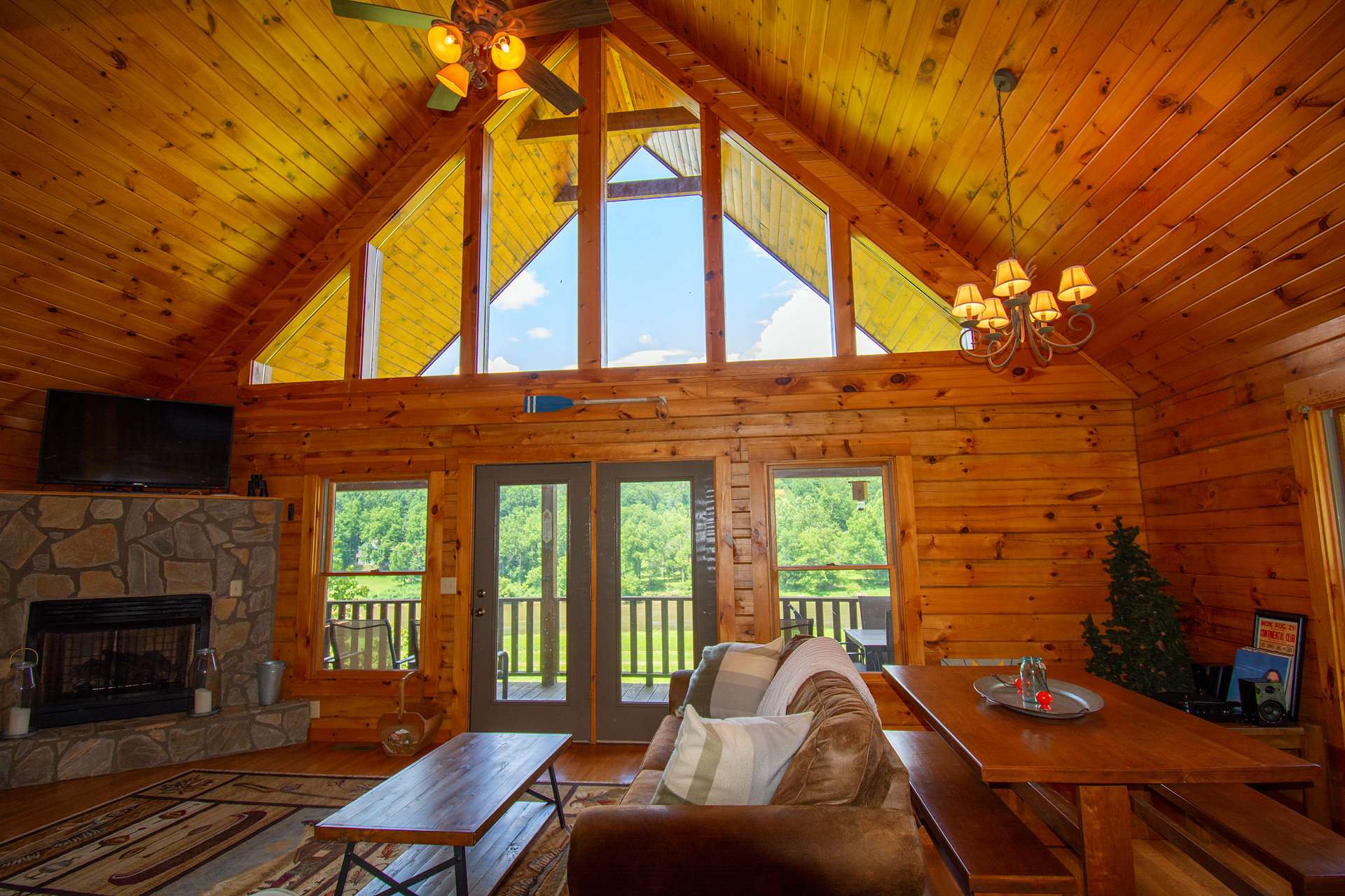 Enter the spacious great room featuring wood floors, stone fireplace and soaring vaulted ceiling with high windows filling the common area with natural light and an incredible view of the New River and surrounding mountains.