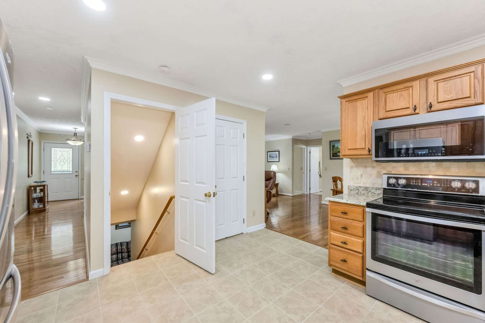 Beside the pantry in the kitchen is the stairway leading to the lower level.