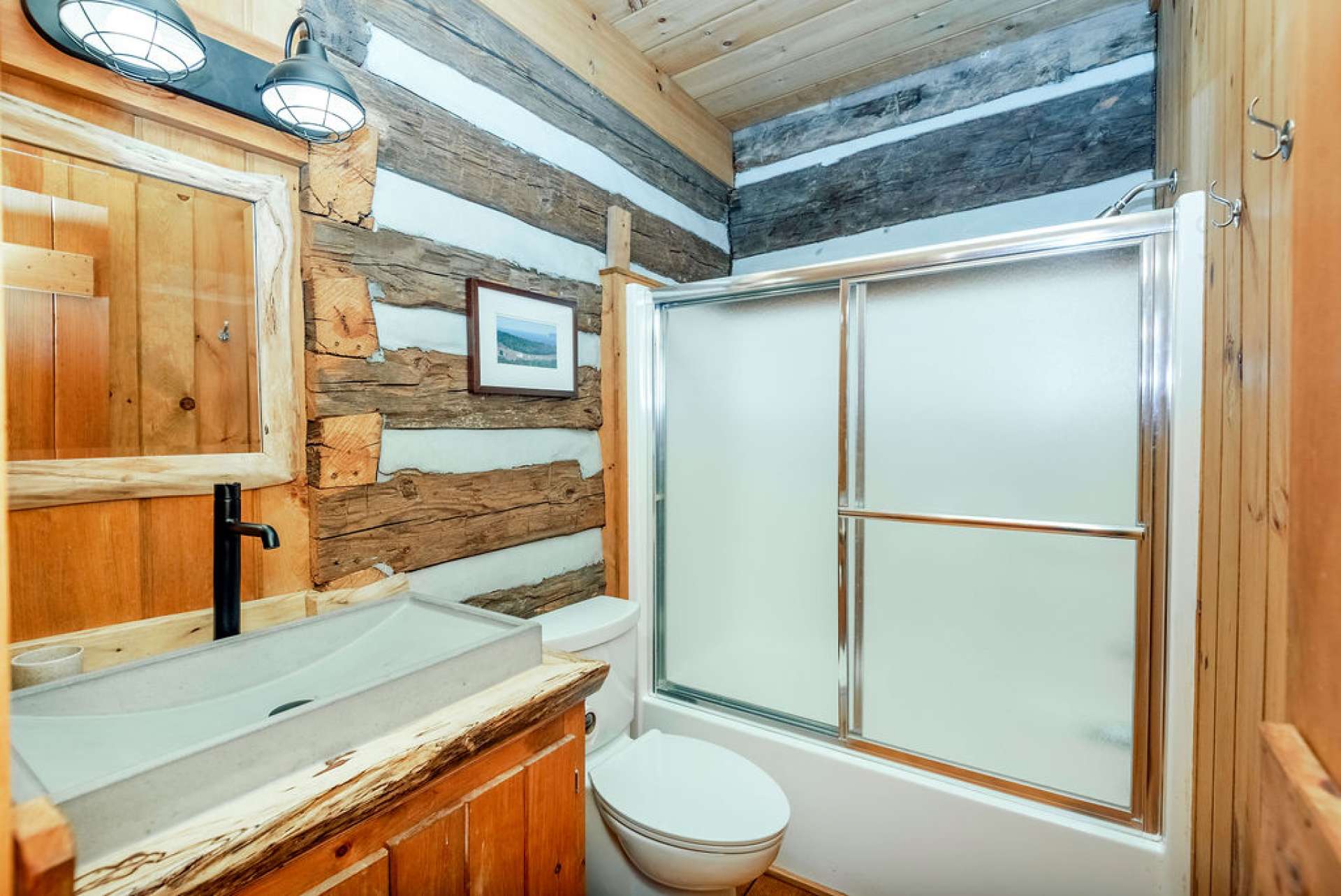 Main level guest bath located in the hall across from laundry and guest bedroom.