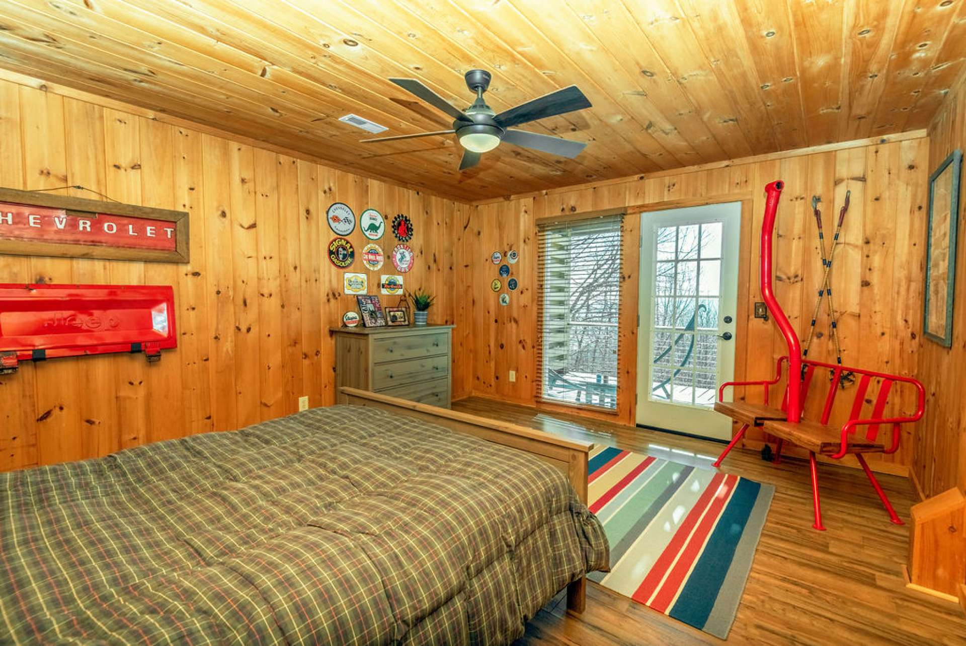 Door leading to lower deck and large window let in the outdoors and light.