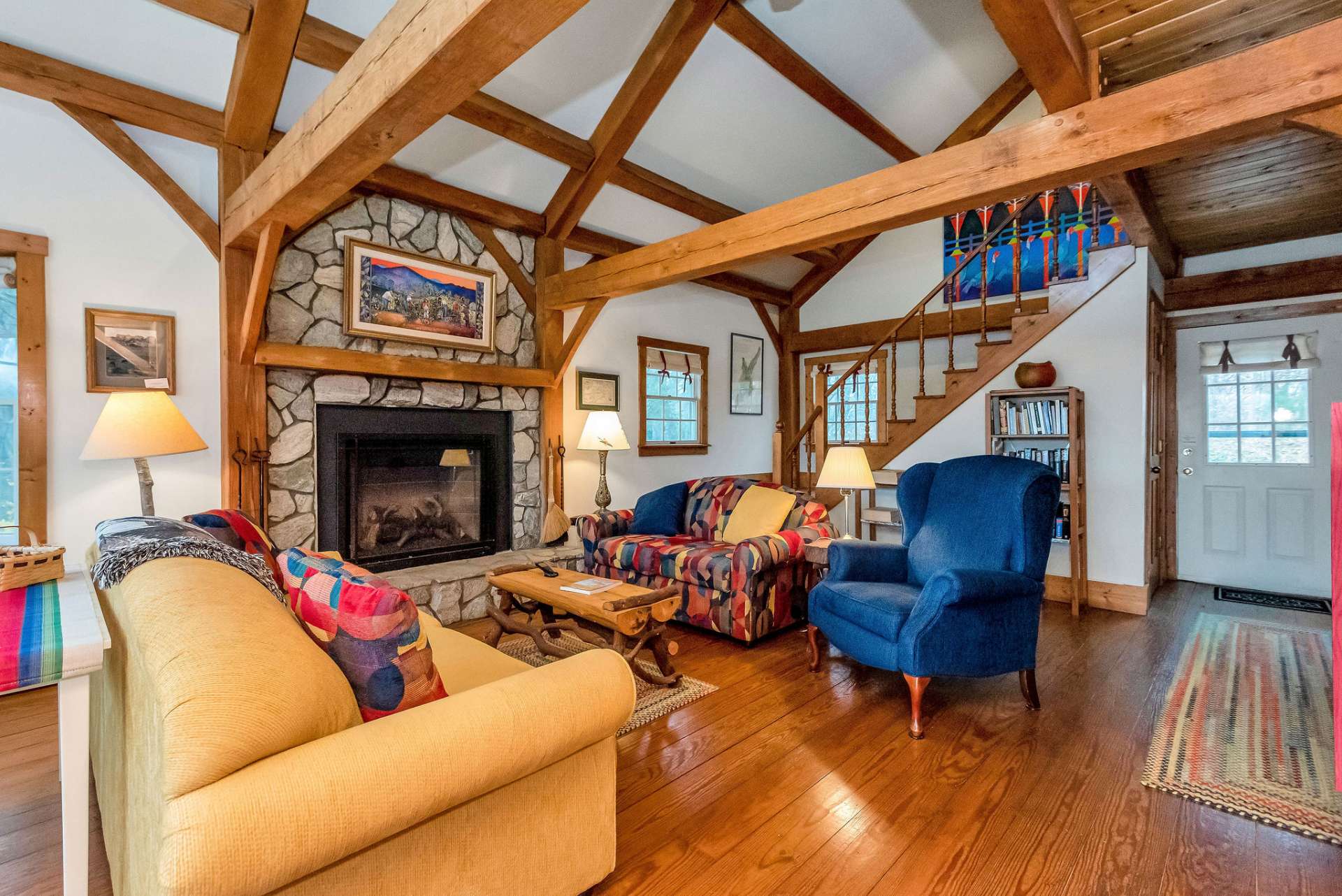 Vaulted living area with stone fireplace