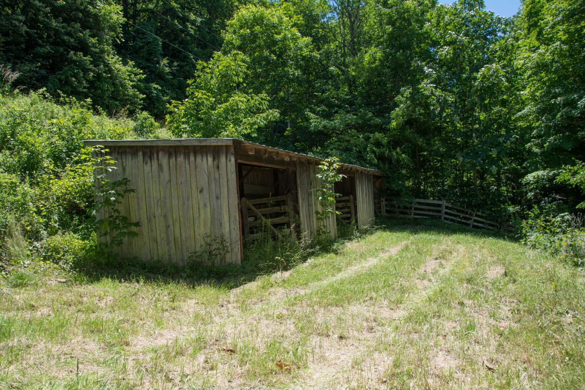 This outbuilding allows for storage of farm or lawn equipment.  Everything here provides for a mini-farm experience or those looking to escape to a country lifestyle.