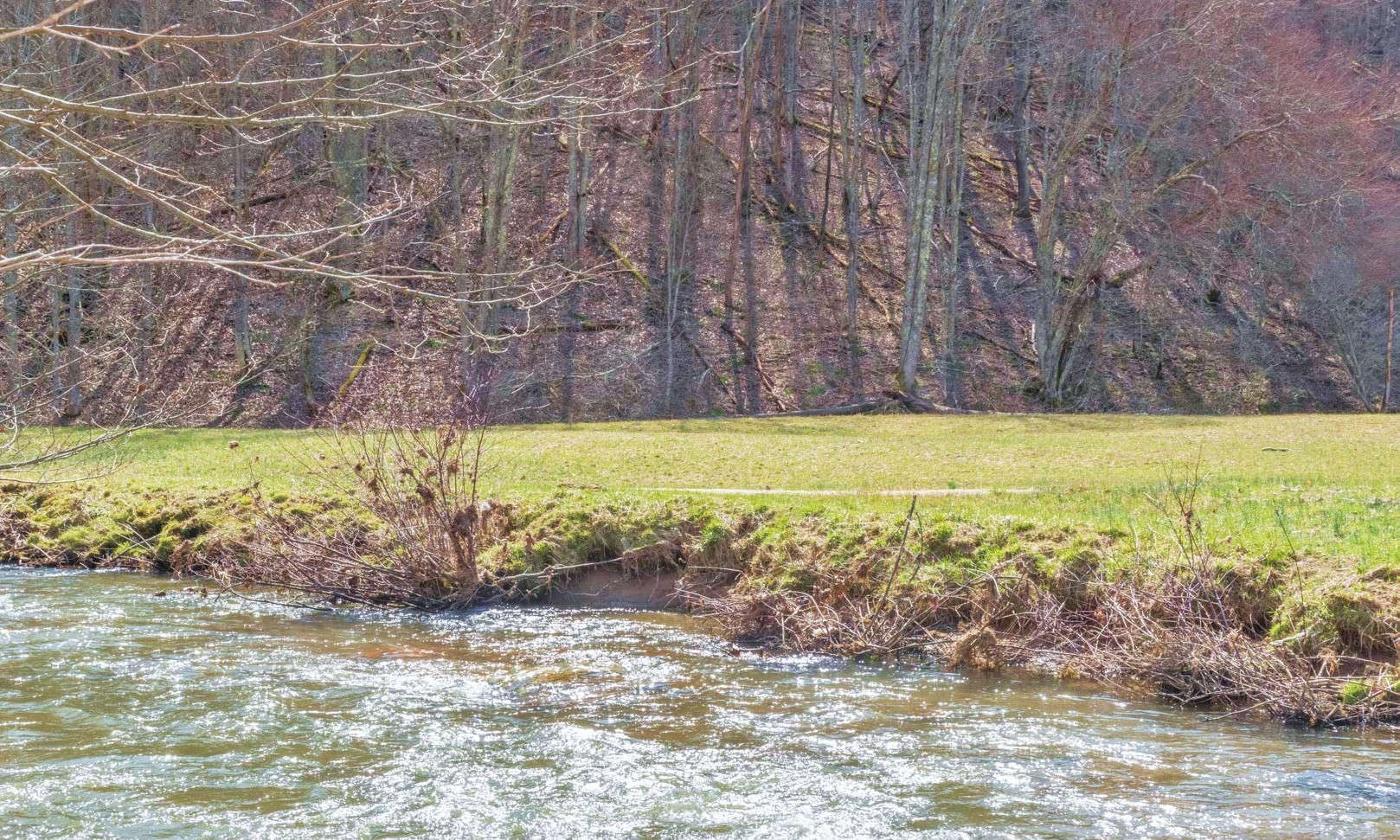 NC MOUNTAIN RIVERFRONT ACREAGE TRACT! Located in the River Breeze Estates community located in the Creston area of Ashe County, this 11.58 acre tract offers beautiful mountain views at the top of the tract, and serene New River views and frontage at the lower portion of the tract.