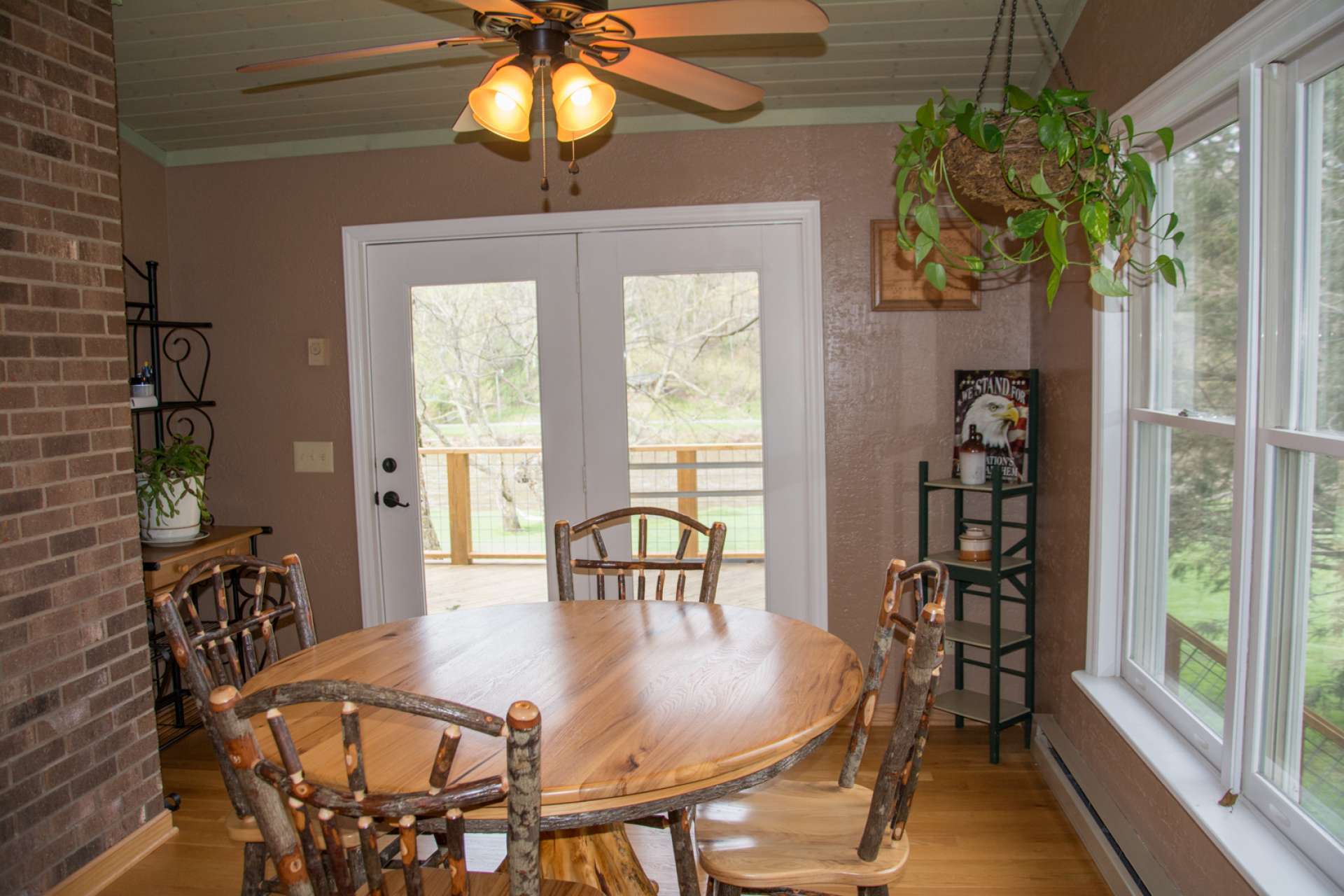 The dining area takes advantage of the outdoor scenery when dining inside and also offers easy access to the open back deck.