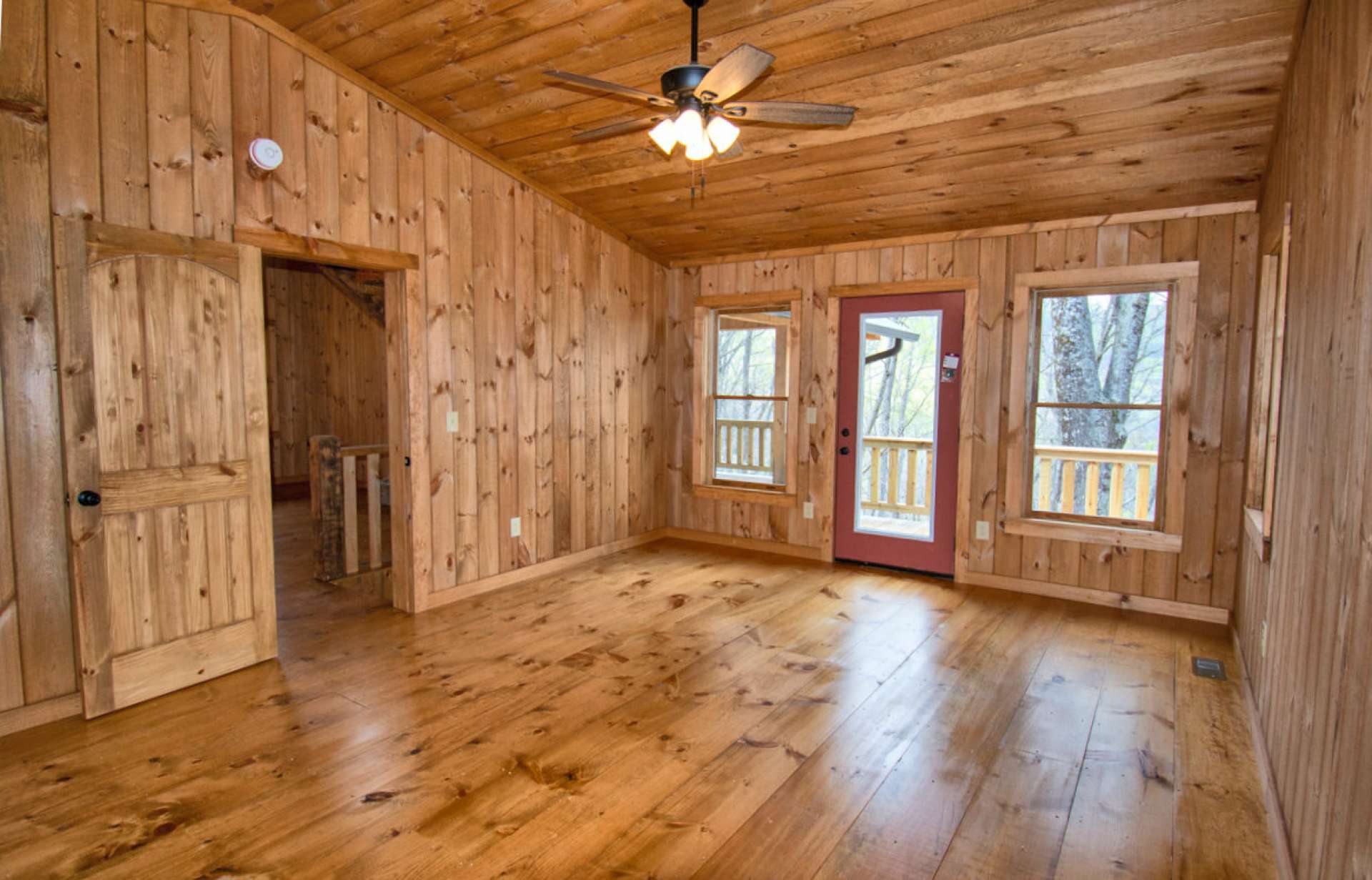 The main level primary bedroom includes a walk-in closet, private bath, and access to the deck.