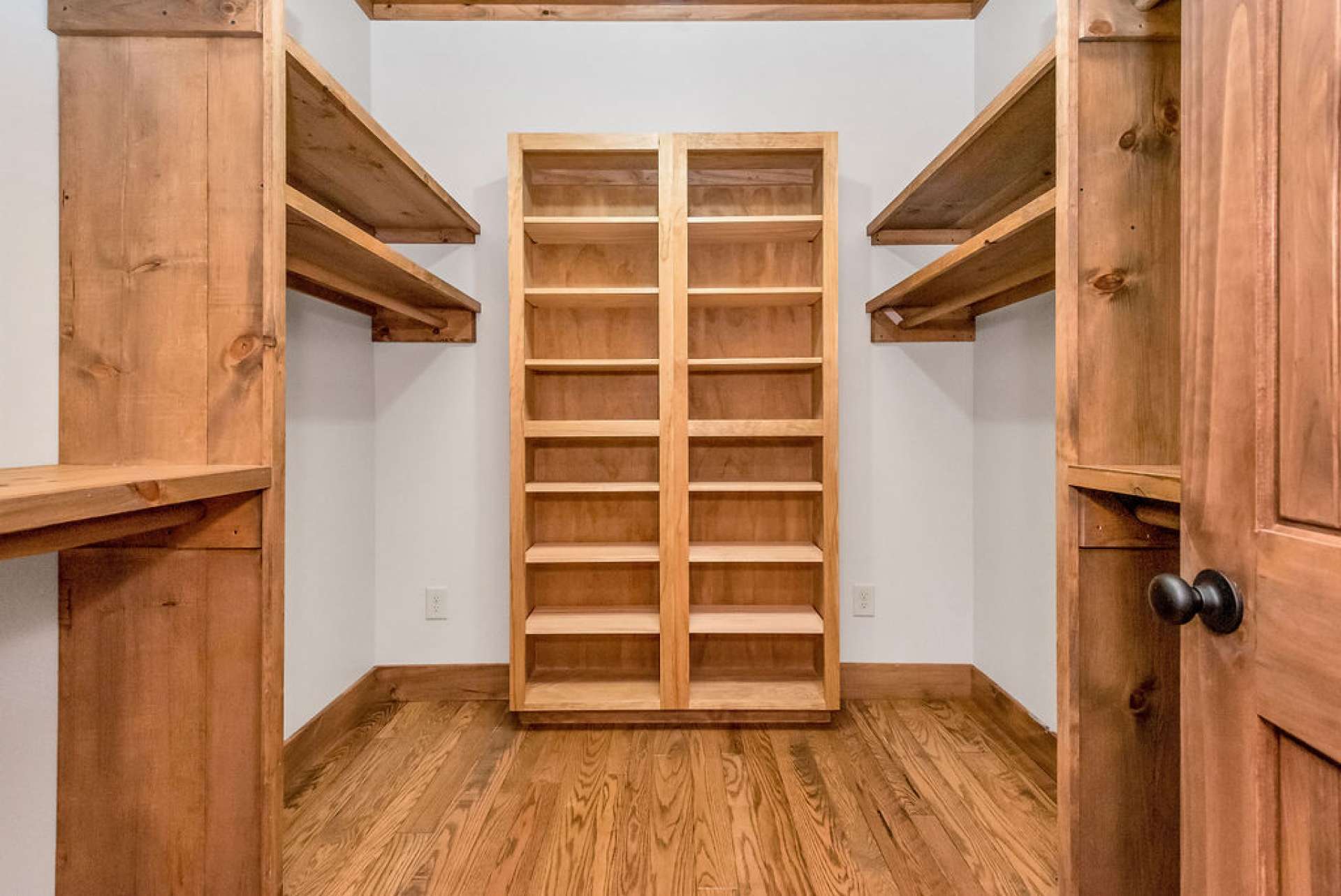 Sizeable closet with well-designed closet system in place.