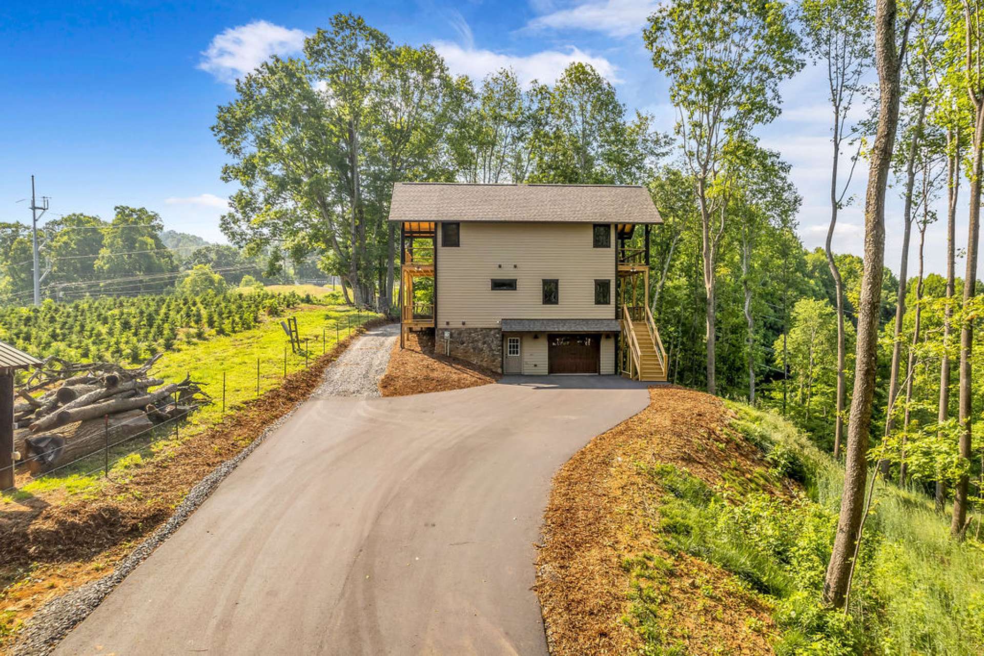 Paved driveway leads to a one-car garage in the lower level.