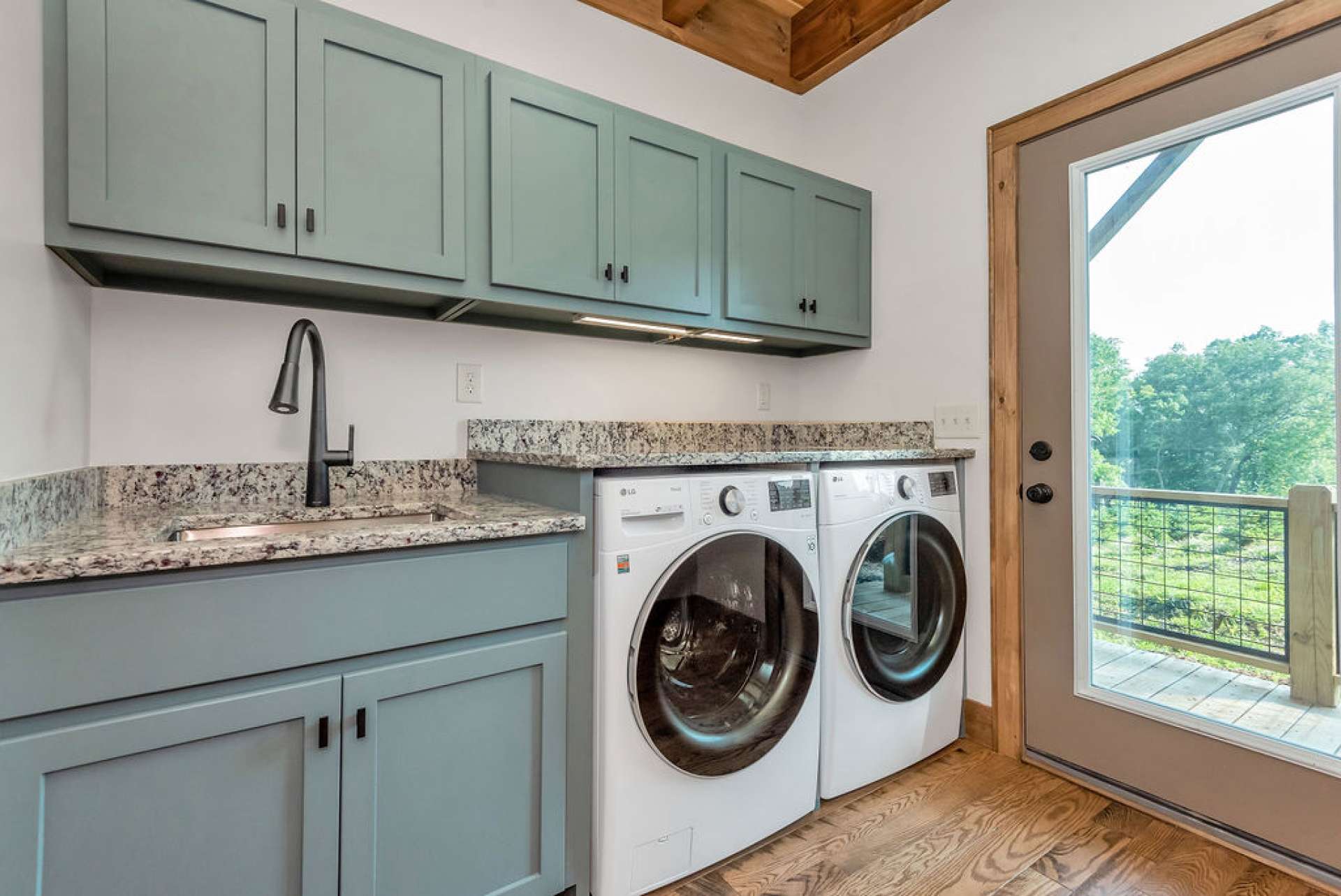 Laundry room also on main level and offering abundant cabinetry and access to rear deck.