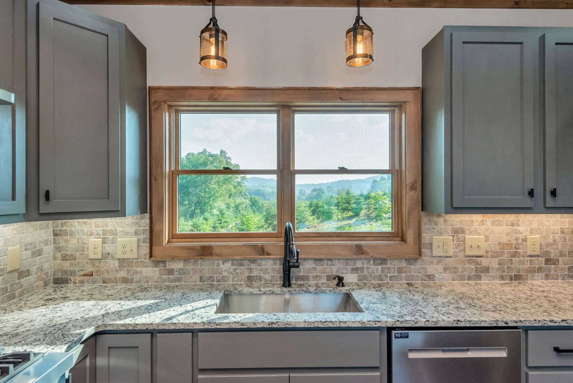 Tile backsplash blends perfectly with the granite counter top.