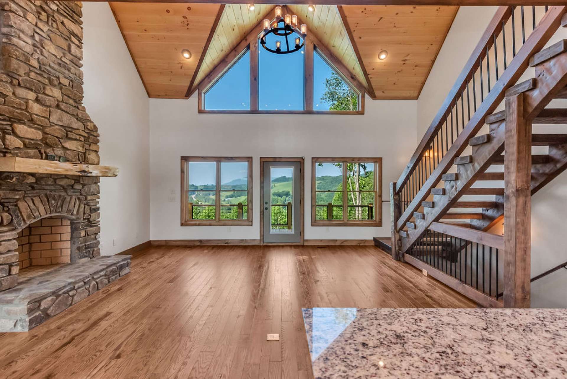 Spacious great room features high vaulted ceiling with lots of windows to take advantage of the natural light and the beautiful view.